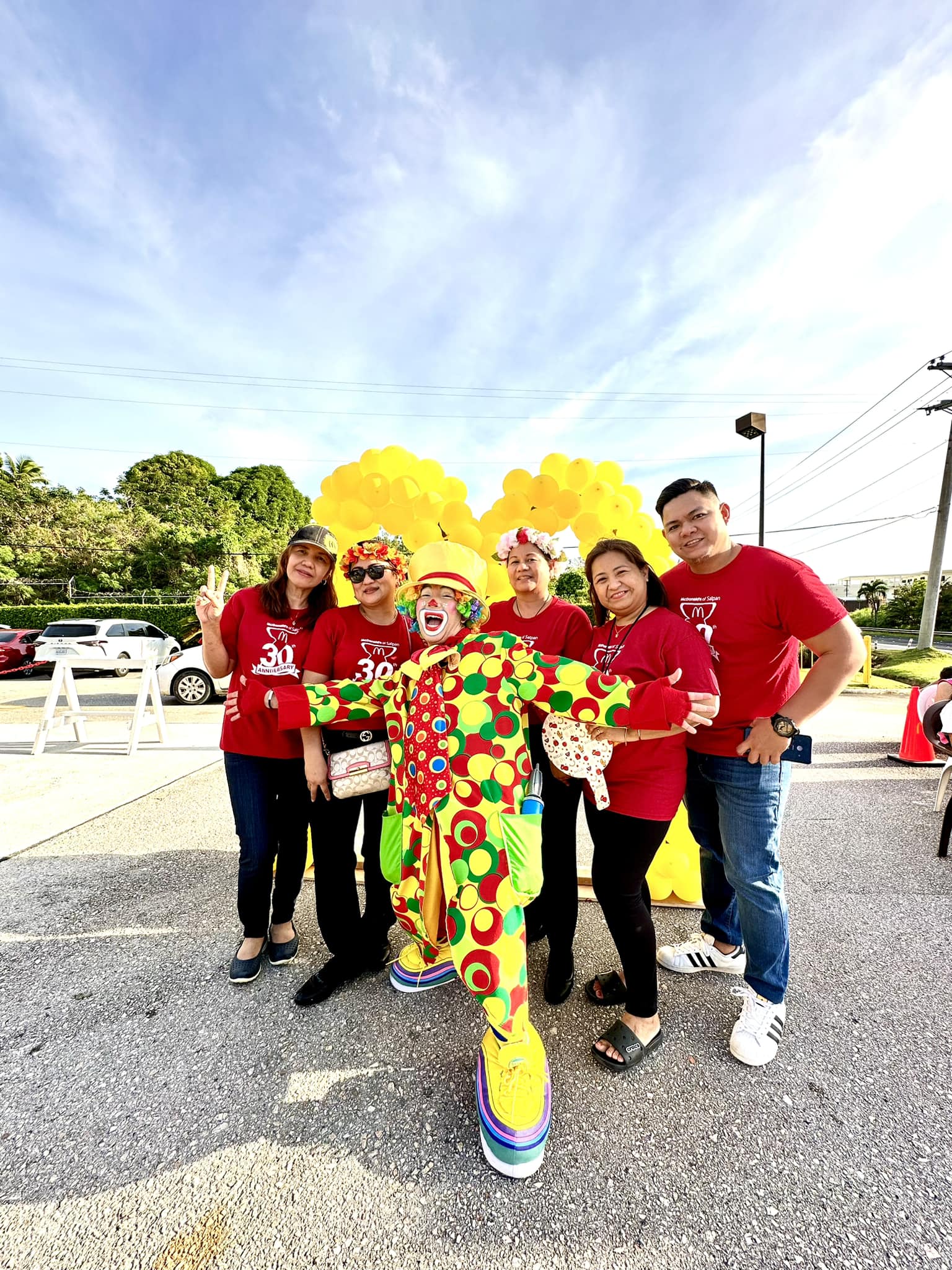 Marissa Obtinalla, McDonald’s accountant; Ruthzel Perez, general manager of McDonald's Garapan; Joyce Asistores, general manager of McDonald's Chalan Laulau; Narme Mendoza, McDonald’s computer support specialist; and Leonard Cabanting, purchasing assistant pose for a photo with Hapi D' Clown as Ronald McDonald during the 30th anniversary celebration of McDonald’s Saipan at its Chalan Laulau branch on Middle Road, Saturday, March 18, 2023. 