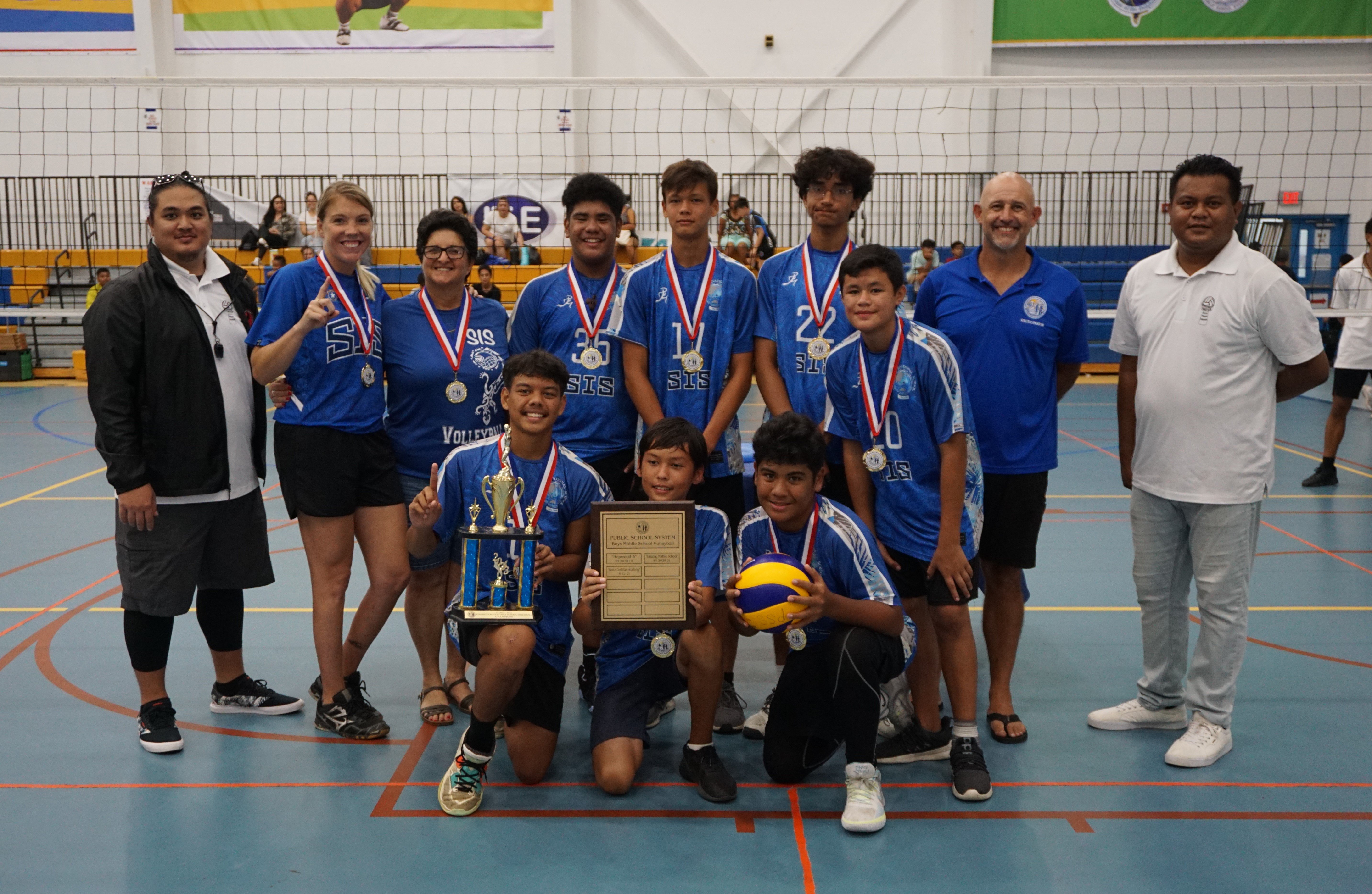 Saipan International School’s volleyball team members pose for a photo with PSS Athletics Program Director Nick Gross and NMIVA officials after winning the boys middle school division title of the NMIVA-PSS Interscholastic Volleyball League on Saturday at the MHS gym.