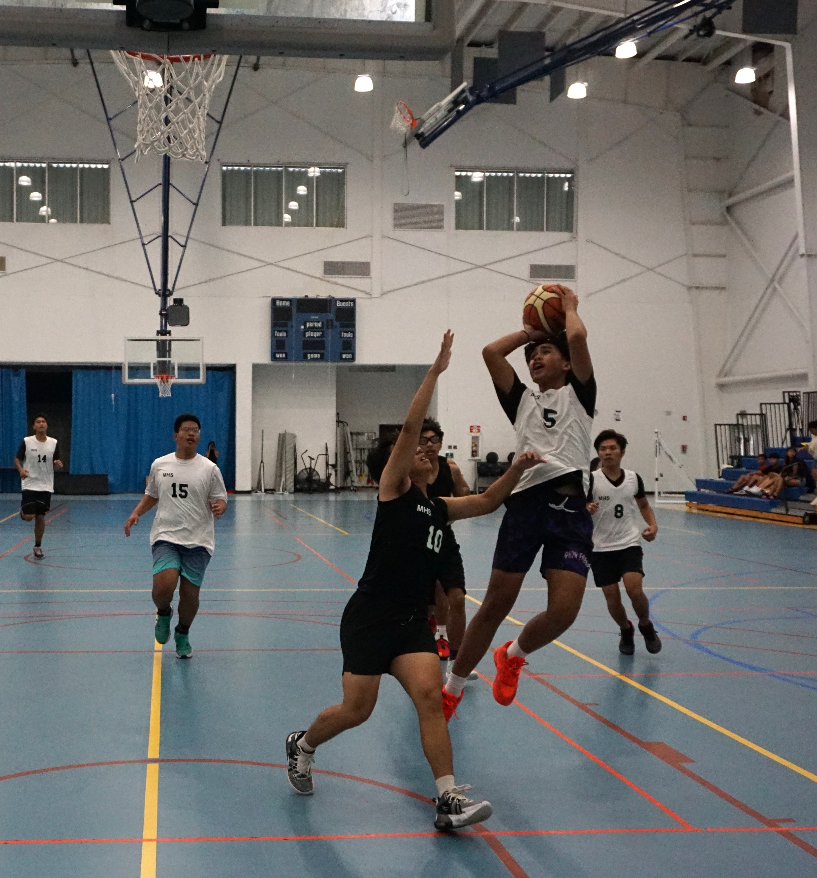 An MHS JV player takes the off-balance shot during a boys high school division game of the IT&E Interscholastic Basketball League at the MHS gym.