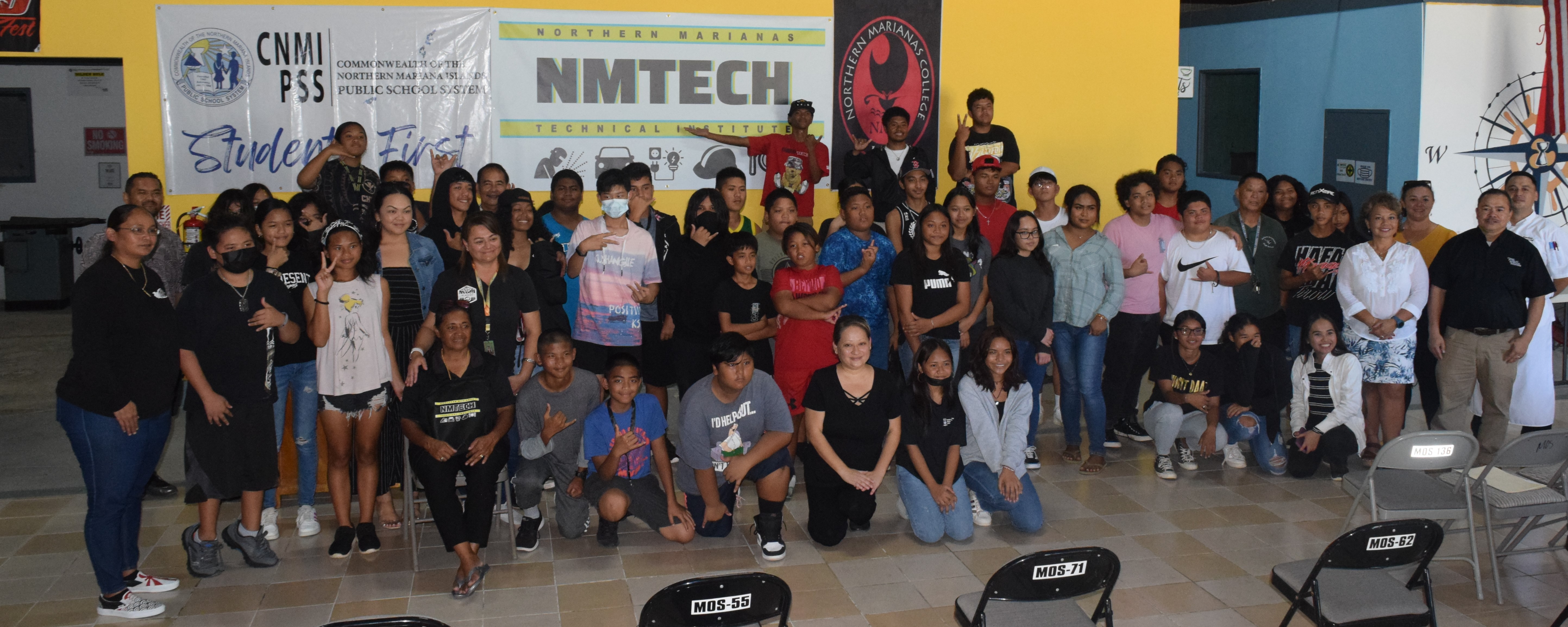 Education Commissioner Alfred B. Ada, second right, acting Labor Secretary Leila Staffler, third right and Northern Marianas Technical Institute Chief Executive Officer Jodina Attao, left, pose for a photo with students who participated in the Career Technical Education & Me event in the NMTech hall on Monday.