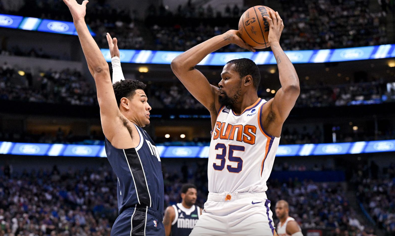 Phoenix Suns forward Kevin Durant (35) looks to pass the ball around Dallas Mavericks guard Josh Green (8) during the first quarter at the American Airlines Center in Dallas, Texas, March 5, 2023.