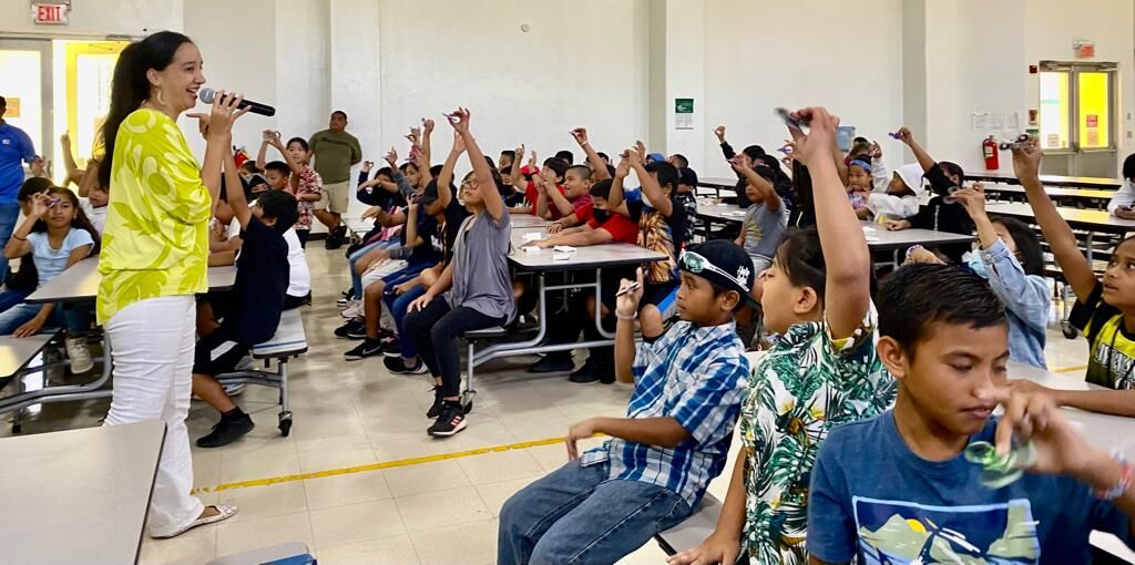 Marianas Tourism Education Council  Board Member Catherine Perry invites 4th and 5th graders of San Vicente Elementary to respond to questions using their “tourism turners” during an educational outreach by MTEC and Marianas Visitors Authority on March 6, 2023, in Saipan.
