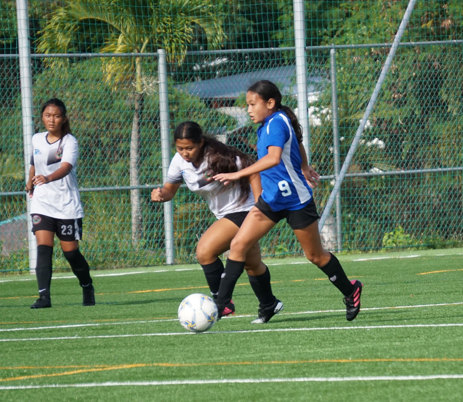Pursued by a defender, SIS' Aubrey White  dribbles forward during a girls middle school division game of the NMIFA-PSS Interscholastic Soccer League on Tuesday at the NMI Soccer Training Center.