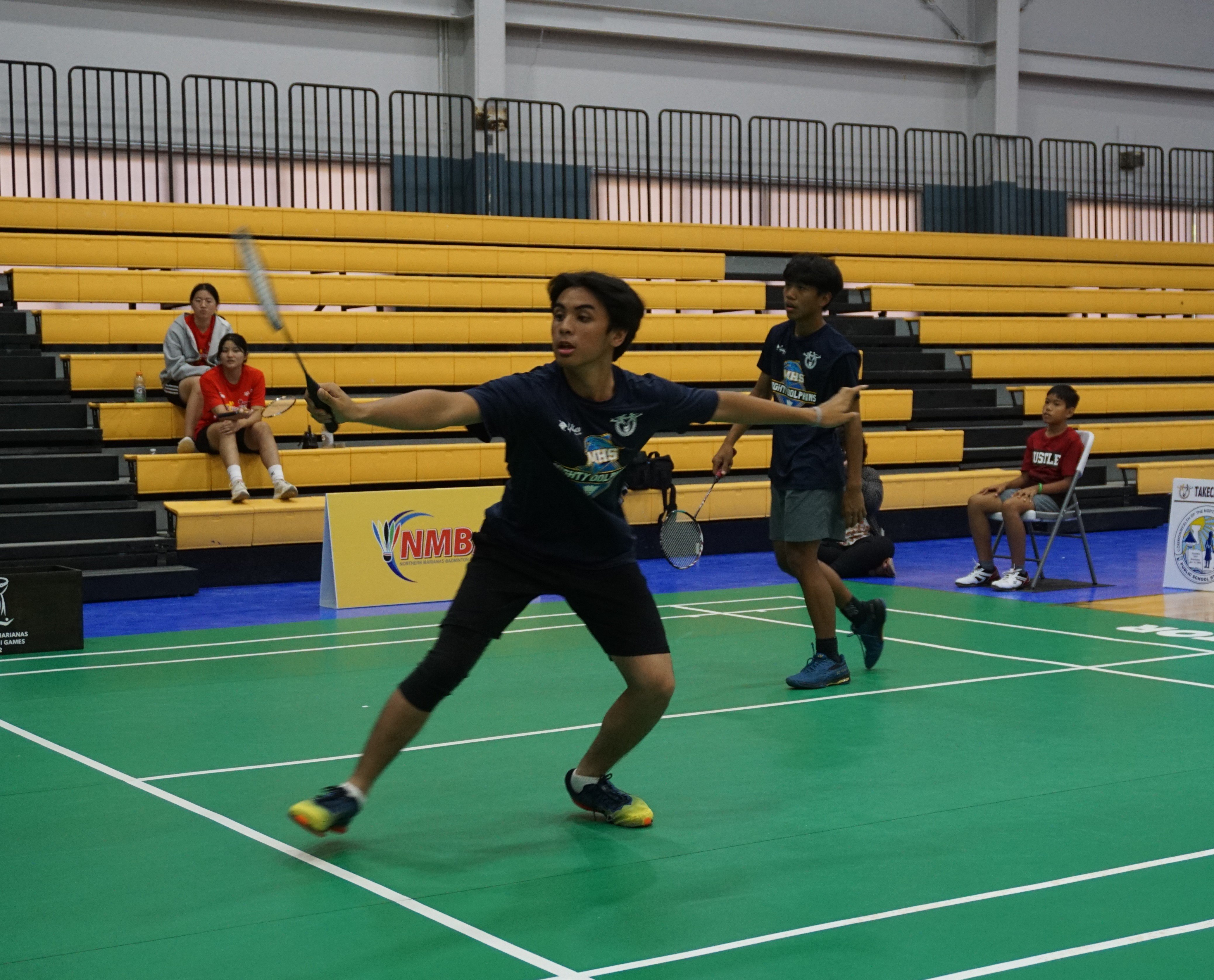 MHS 2's Marlon Bautista connects a backhand return in the boys doubles event.