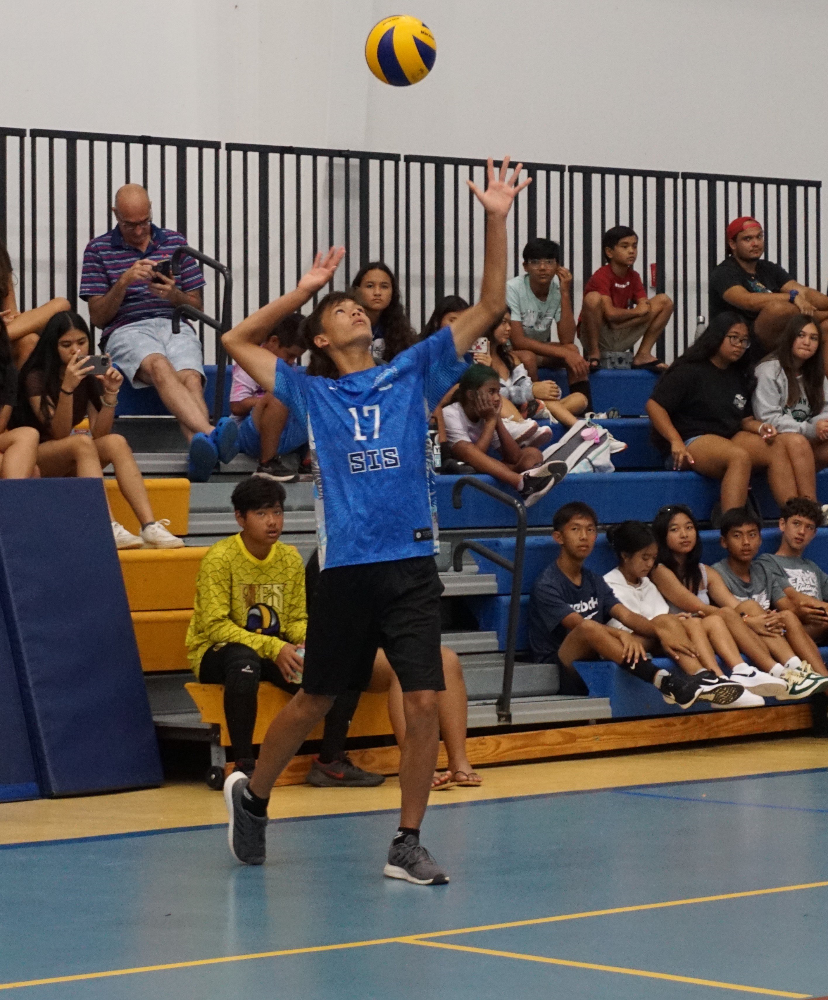 SIS' Moshe Sikkel attempts the overhead serve during the boys middle school division championship match of the NMIVA-PSS Interscholastic Volleyball League on Saturday at the MHS gym.