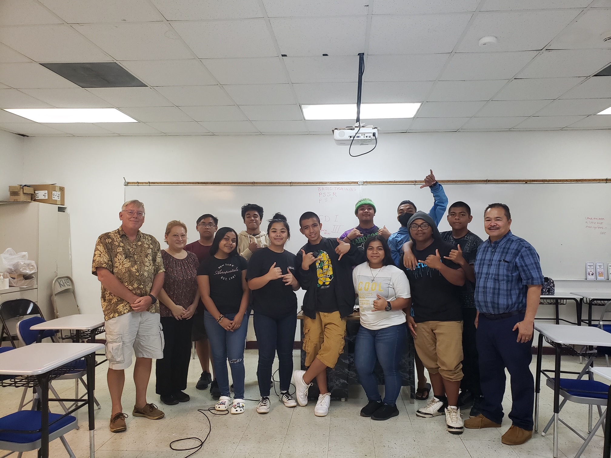 From left,  Captain Dave Johansen, Public School System Career & Technical Education Program Director Dr. Jessica Taylor, Midshipman Cruz, Aguon-Presot, Jace, Yanai, Tudela, Borden, Tomokane, L Reyes, Salta, M Reyes, Kapileo and Education Commissioner Dr. Alfred Ada.