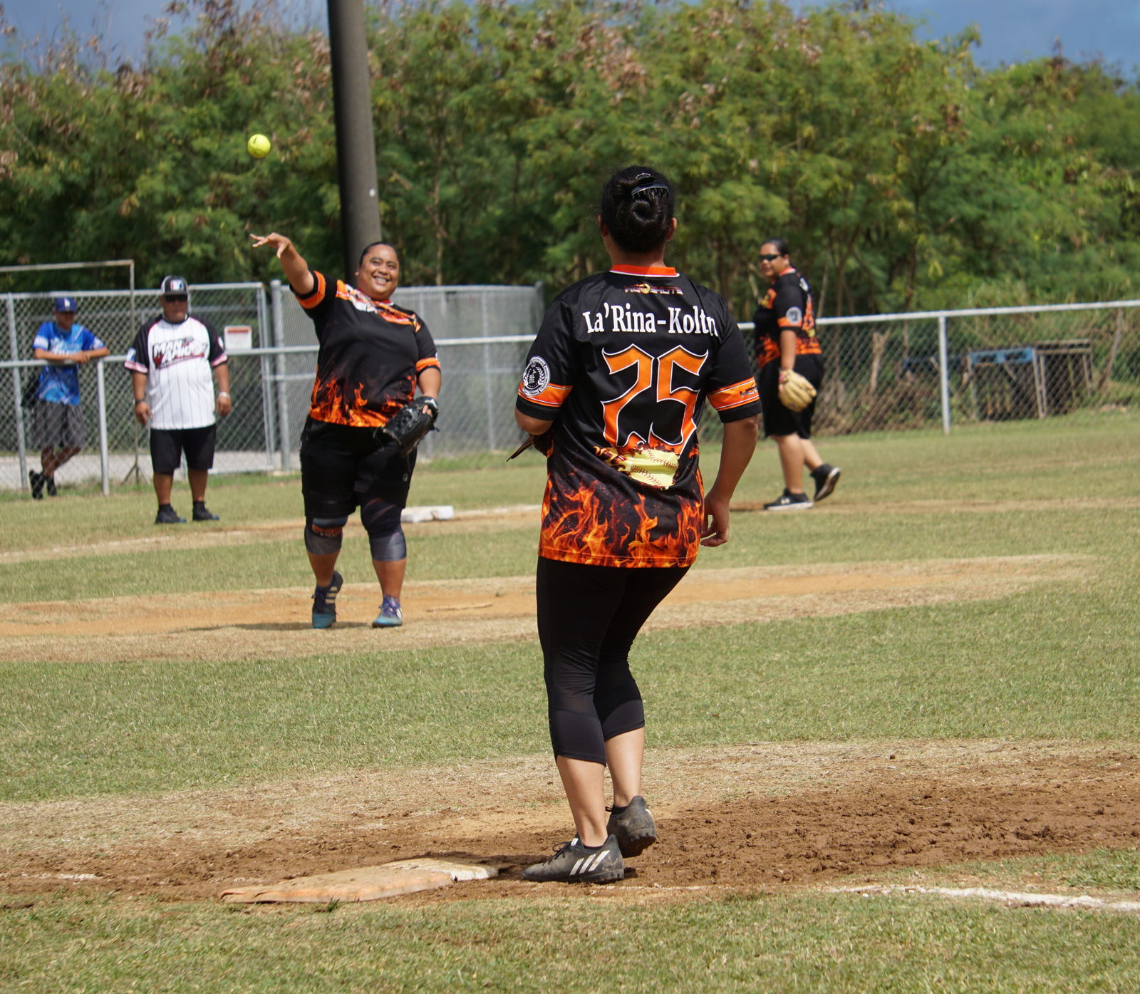 Hot Shots pitcher Janice Celis smiles as she throws to first base for the out during a ladies division game of the 2023 Budweiser Belau Amateur Softball League at the Dandan baseball field on Sunday.
