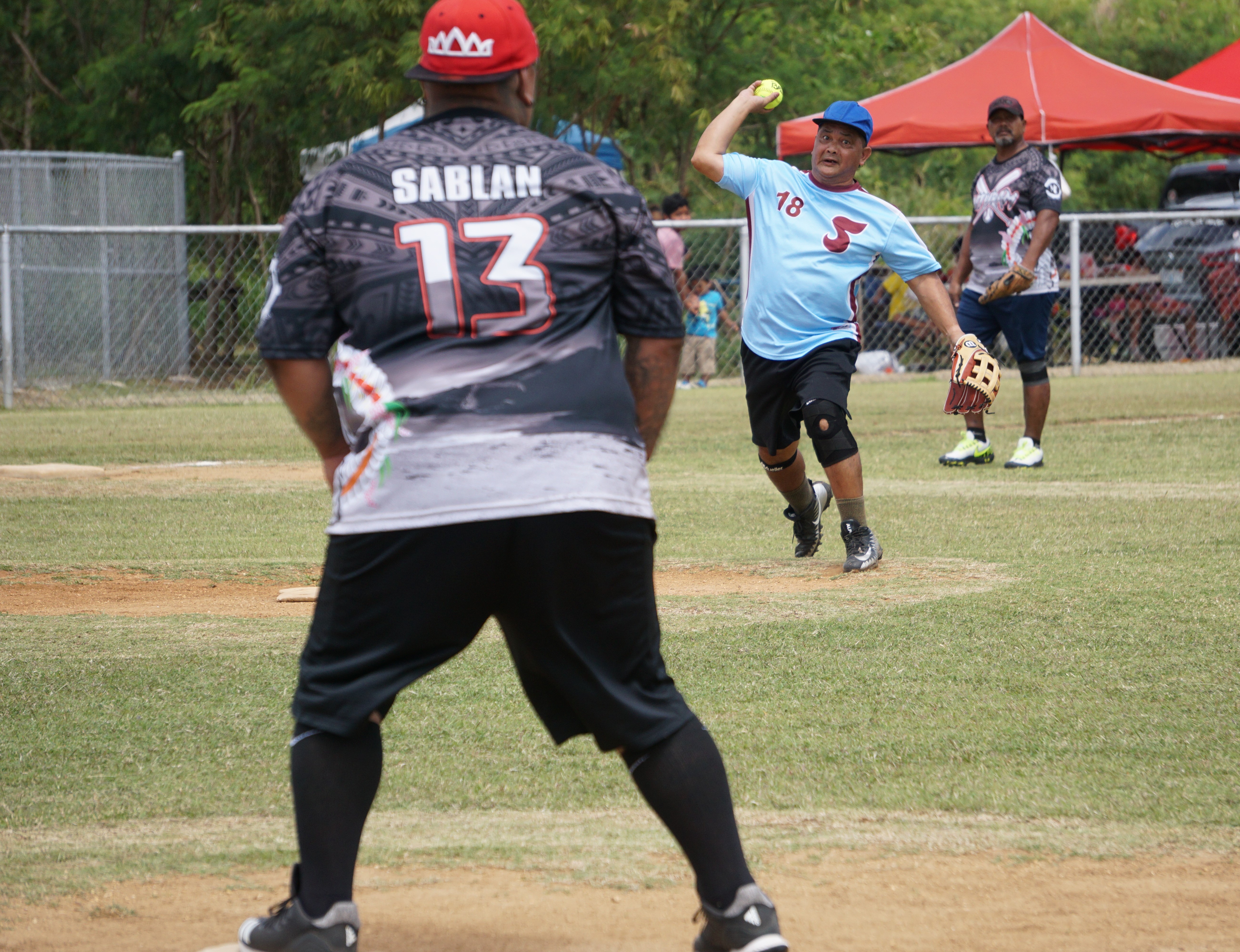 Tuturamz pitcher John Maratita throws to first base for the out during a 2023 Budweiser Belau Amateur Softball League  game Sunday at the Dandan baseball field.