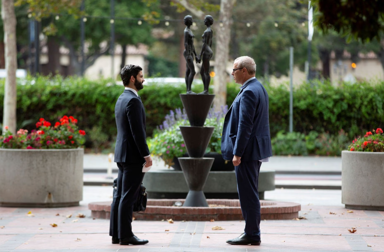 Theranos lab director Adam Rosendorff, right, stands outside of the Robert F. Peckham U.S. Courthouse after speaking on the stand during the Theranos trial, in San Jose, California, Oct. 6, 2021.
