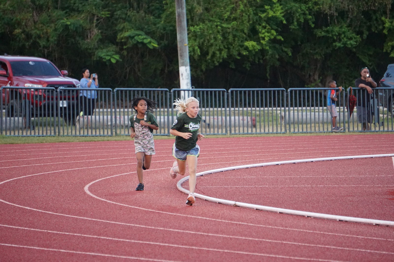 Oleai Elementary School's Kaylen Taflinger and Marianne Eugenio lead the U9 Girls 800m race on opening day of the PSS-NMA All School Athletics at the Oleai Sports Complex on Tuesday.