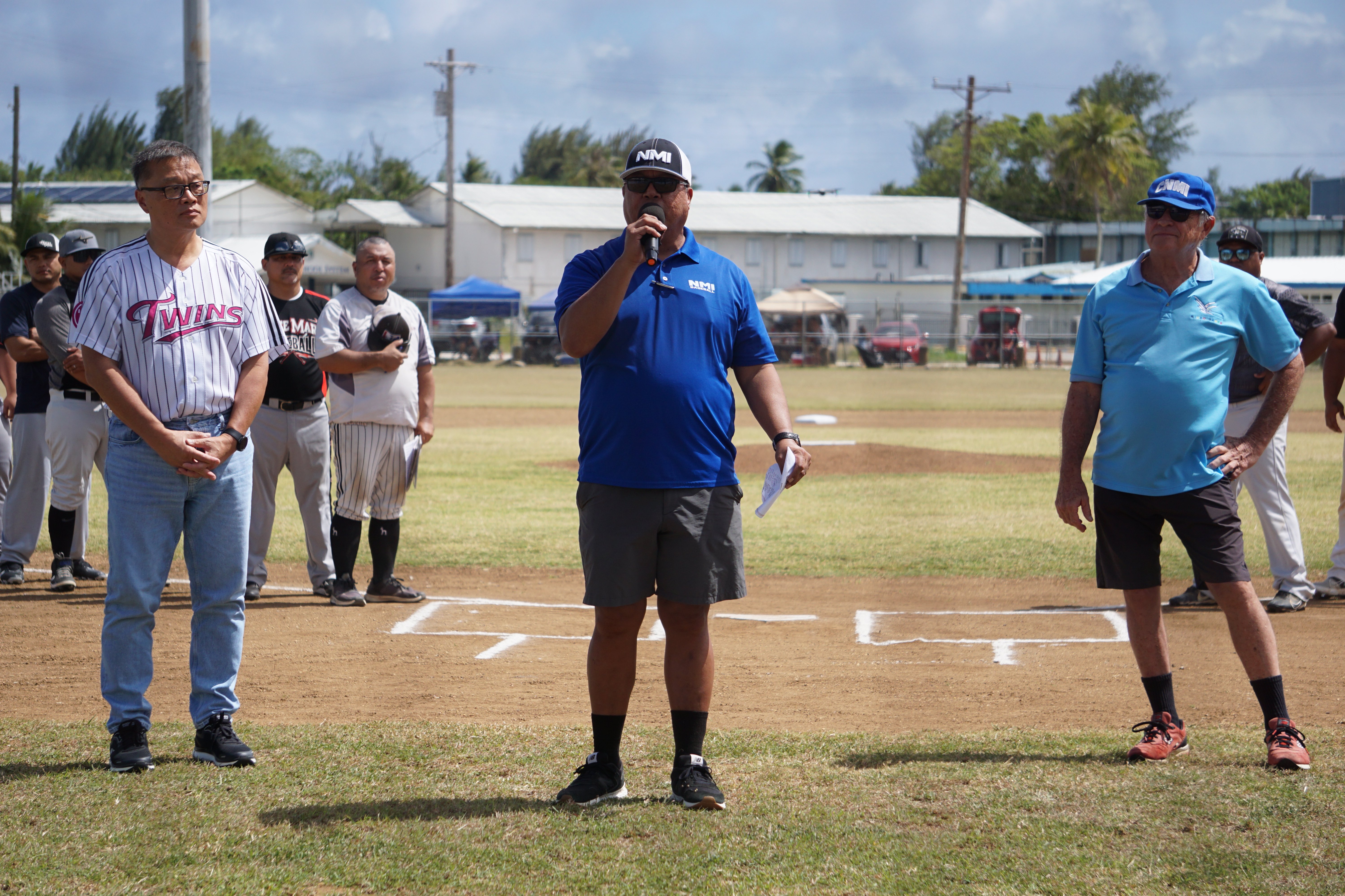 Jay Santos, center, delivers his remarks during the opening ceremony of the Tan Holdings Saipan Baseball League at the "Tan Ko" Palacios Baseball Field on Saturday.