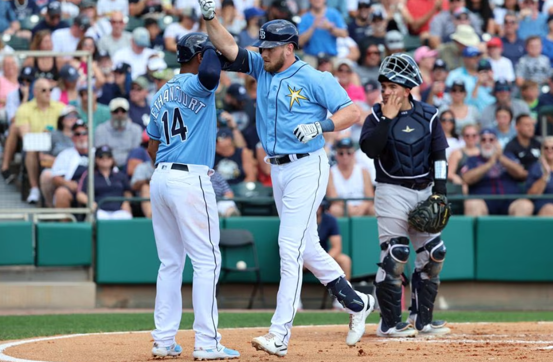 Tampa Bay Rays right fielder Luke Raley (55) is congratulated by Tampa Bay Rays catcher Christian Bethancourt (14) after he hit a 2-run home run during the first inning against the New York Yankees at The Stadium at the ESPN Wide World of Sports in Kissimmee, Florida,  Feb. 28, 2023.