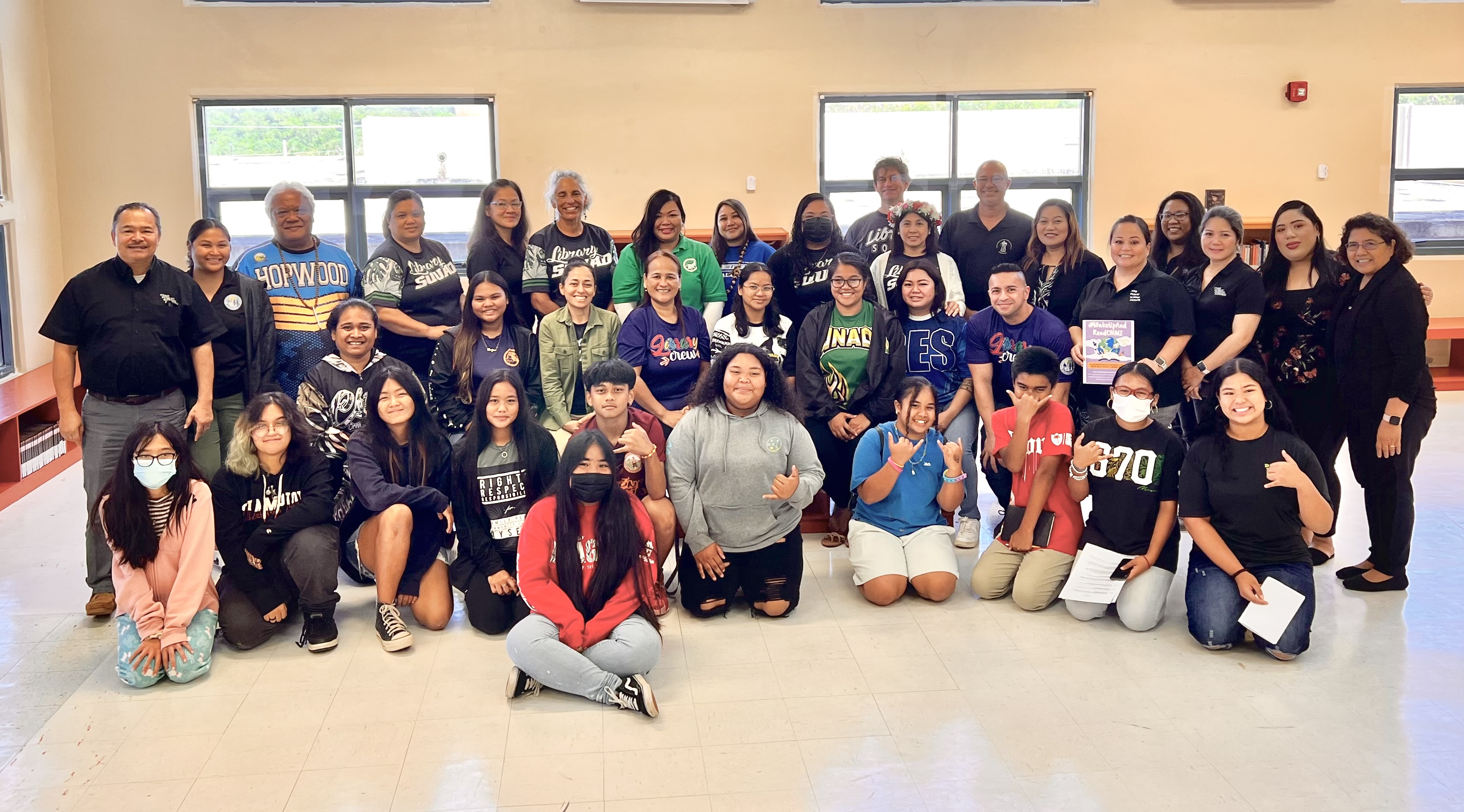 Public school librarians pose for a photo with Board of Education Secretary/Treasurer Gregory Pat Borja, Commissioner of Education Dr. Alfred B. Ada, Senior Director for Curriculum and Instruction Jackie Quitugua, students and other school personnel during the School Library Month proclamation signing ceremony Monday at Chacha Ocean View Middle School.