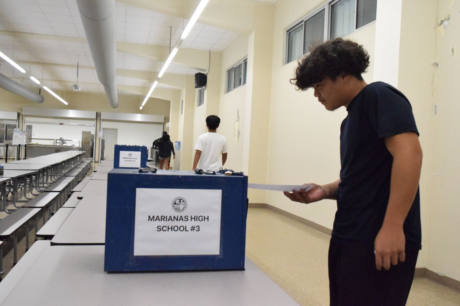 Marianas High School 10th grader Isidro Lizama casts his vote in the MHS cafeteria at 11 a.m. Monday.