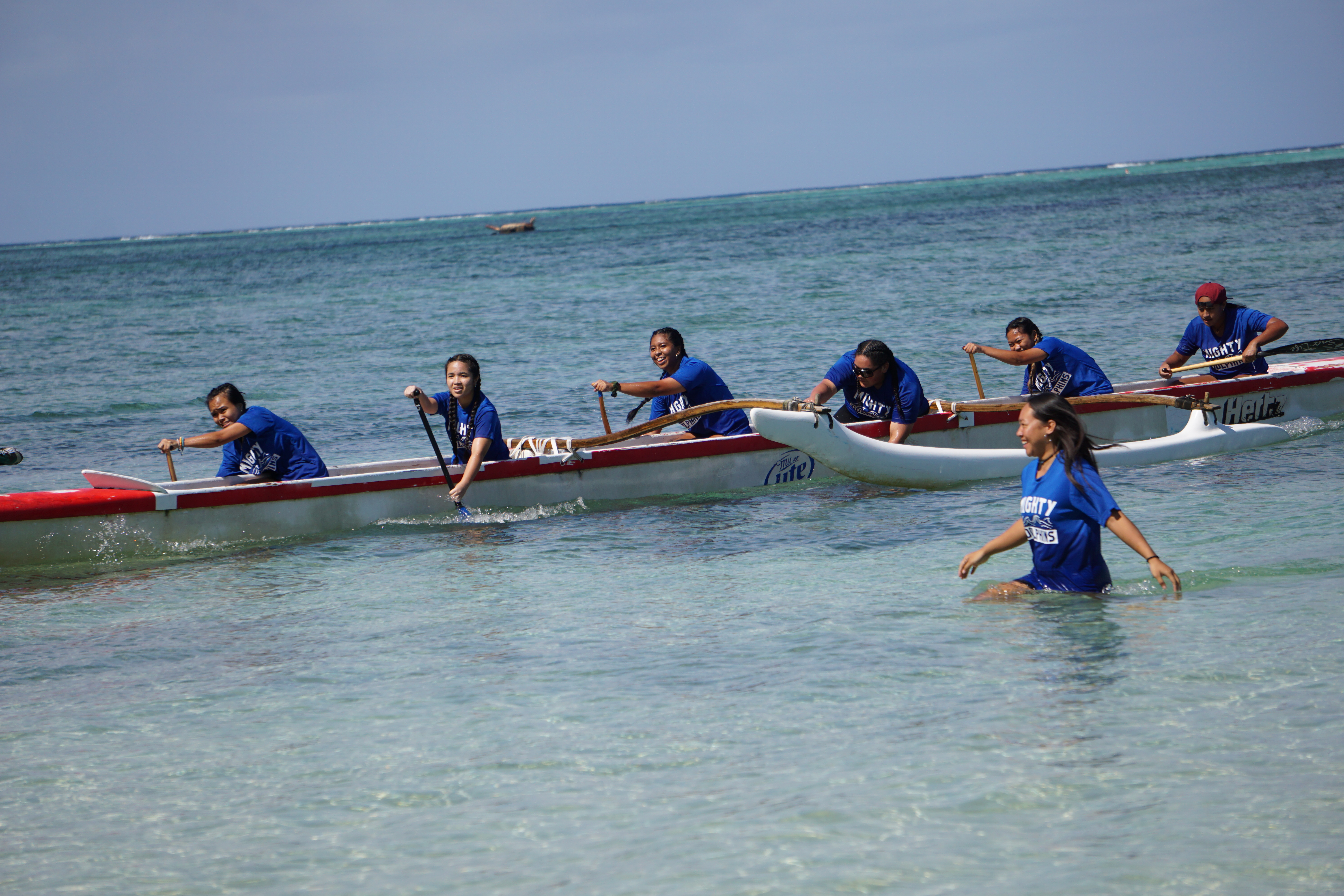The MHS girls team with their coach Tiana Aldan celebrate their first-place finish in the 500m race of the PSS Interscholastic Outrigger Race Series on Saturday at Kilili Beach.