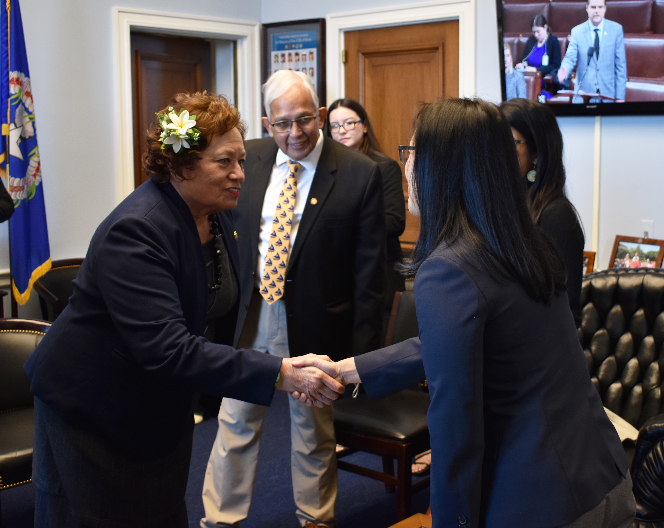 Congresswoman Amata of American Samoa shakes hands with one of the members of the Asian and Pacific Islander Scholars group while former Congressman Robert Underwood of Guam looks on.