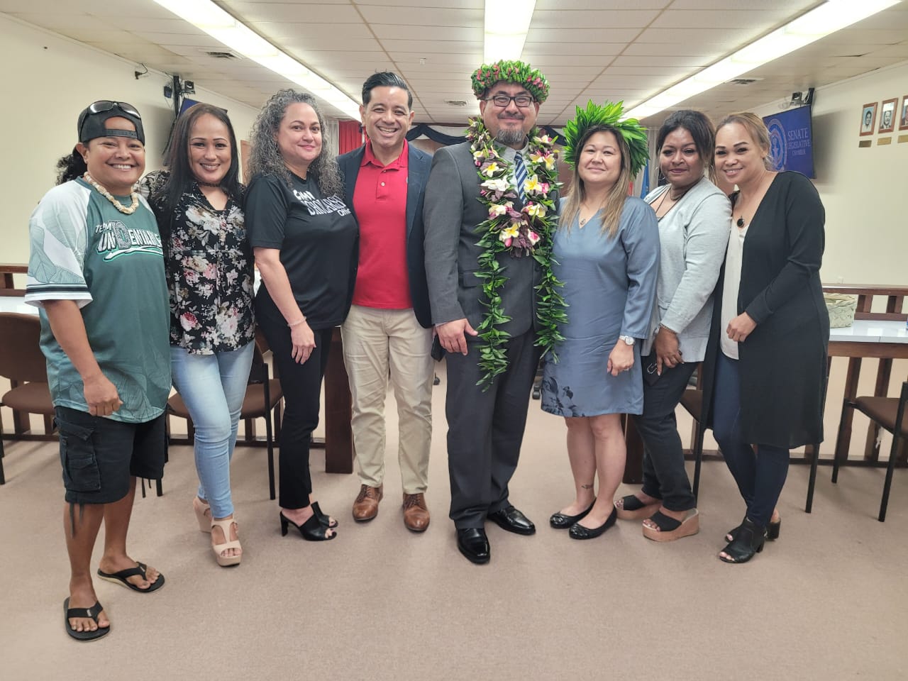 Acting Department of Public Safety Commissioner Clement Bermudes, fourth right, poses for a photo with Northern Marianas College Vice President for Administration and Advancement Frankie Eliptico, center, family and friends after a public hearing in the Senate chamber on Thursday.