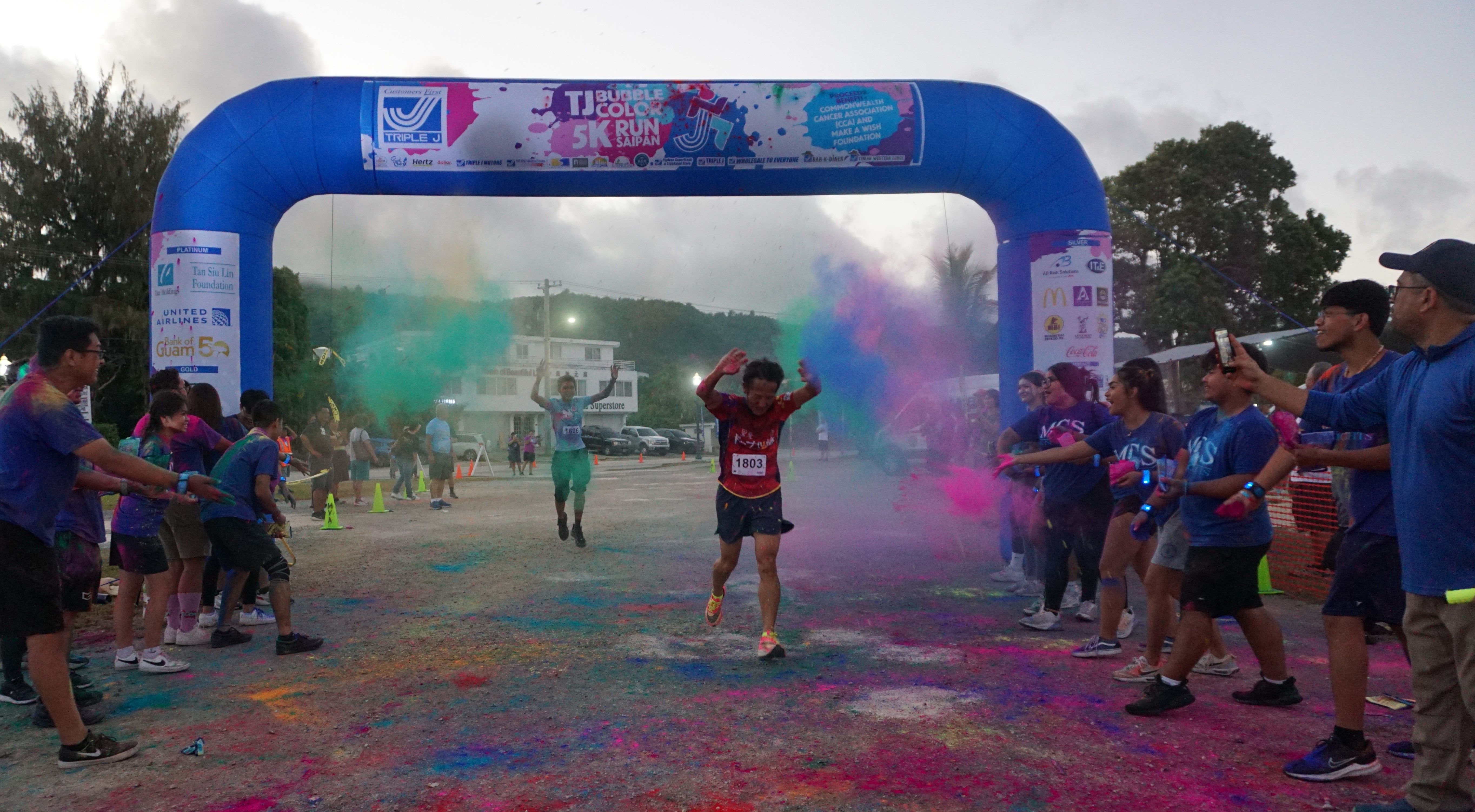 Kosuke Sato celebrates after crossing the finish line.