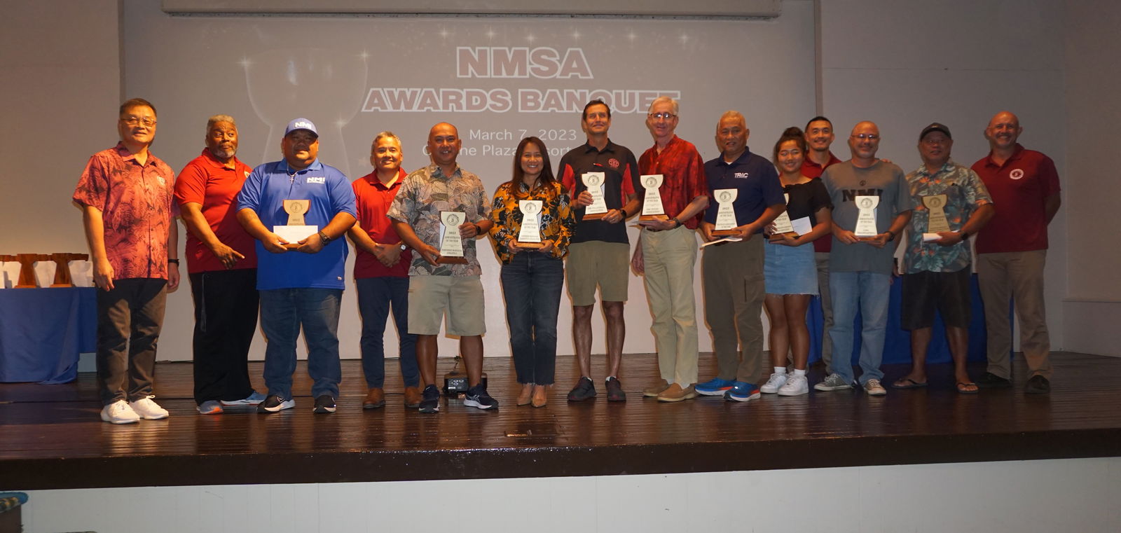 The representatives of the nine sports federations hold their Administrator of the Year awards as they pose for a photo with Northern Marianas Sports Association President Jerry Tan and board members during the NMSA Awards Banquet at the Hibiscus Hall of Crowne Plaza Resort Saipan, Tuesday night.