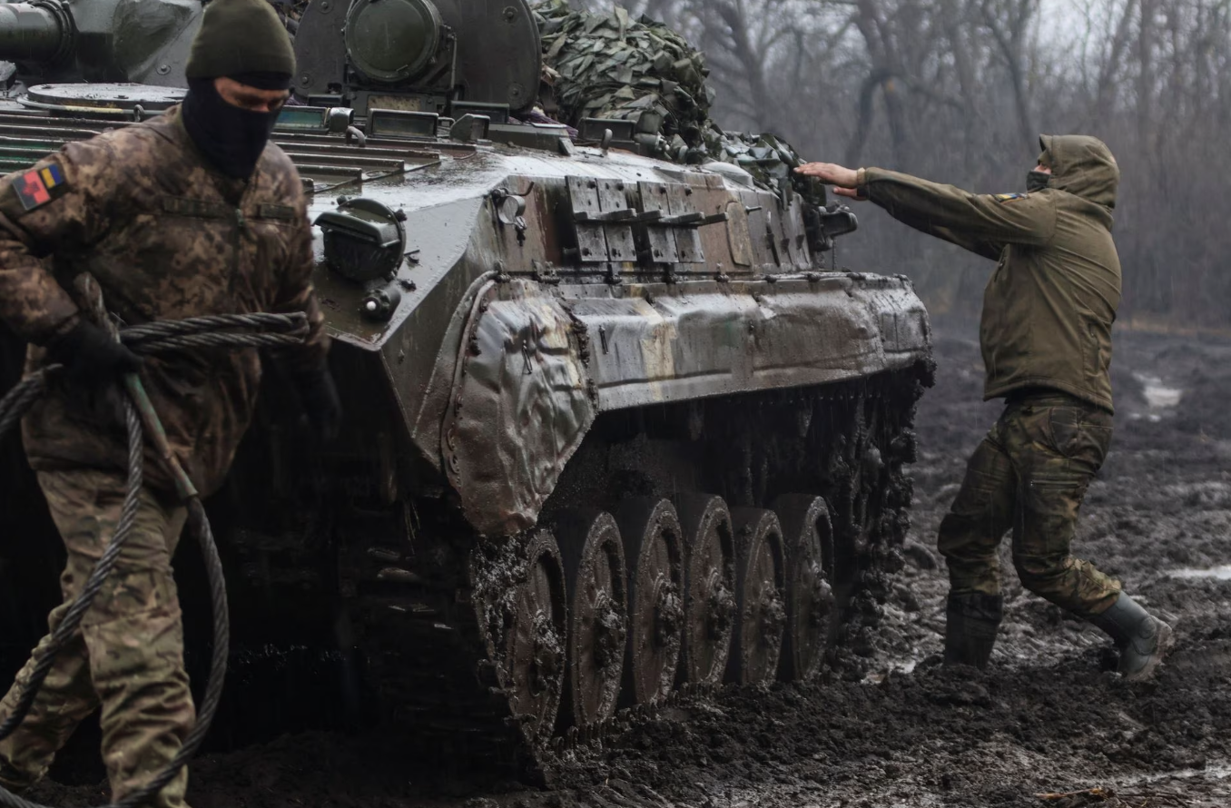 Ukrainian service members are seen next an infantry fighting vehicle near the frontline town of Bakhmut, amid Russia's attack on Ukraine, in Donetsk region, Ukraine Feb. 25, 2023.