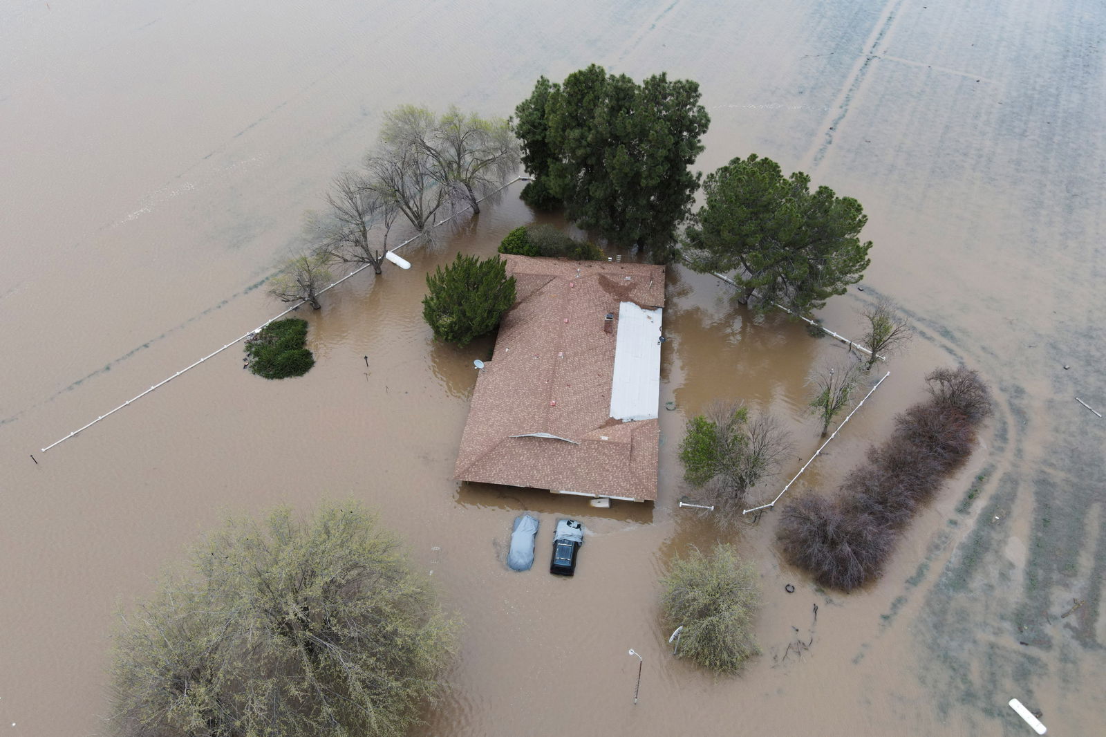 Floodwaters from the Tule River inundate the area after days of heavy rain in Corcoran, California,  March 21, 2023. 