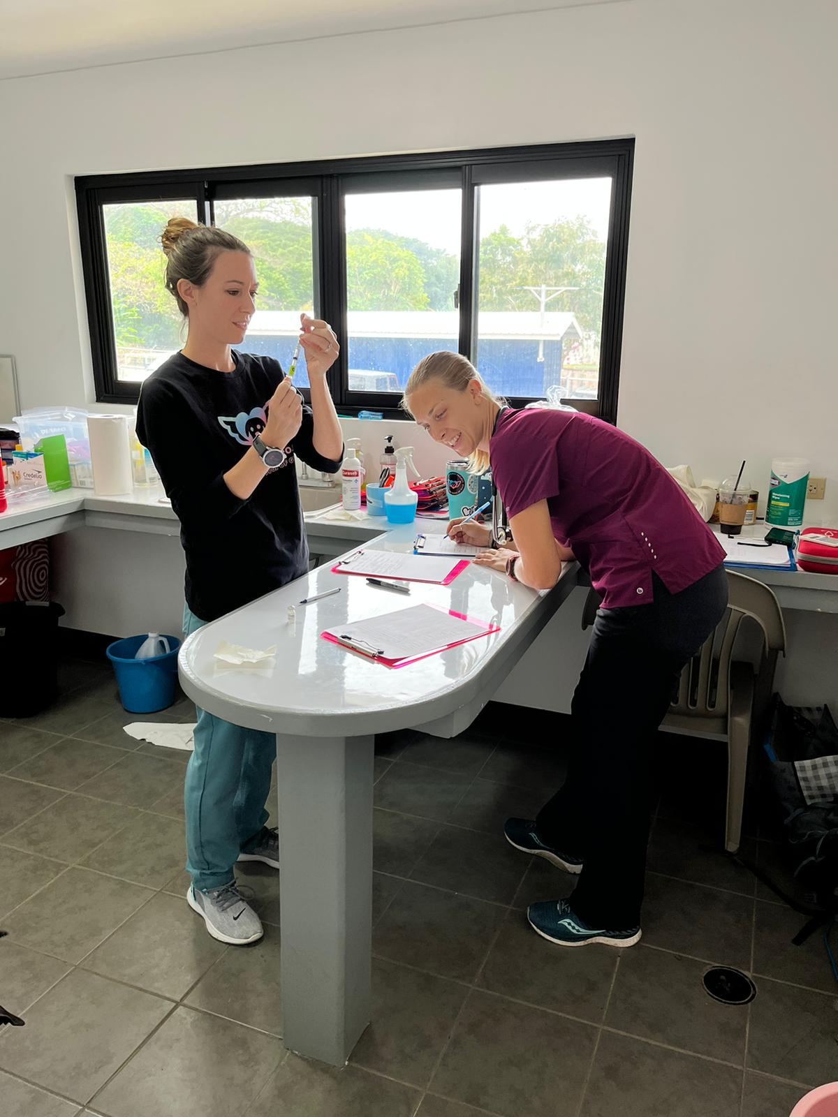 Visiting veterinarian Whitney Collins, right, and Boonie Flight Guam co-founder Lauren Cabrera.