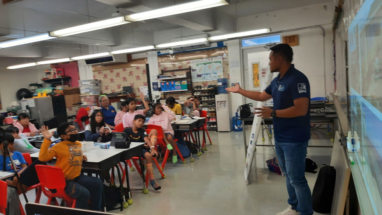 Marianas Visitors Authority Community Projects Specialist Jack Aranda addresses students at Garapan Elementary on March 1, 2023, and shares about the Marianas tourism industry.