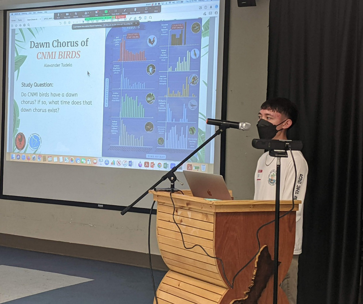 NMC student Alexander Tudela presents his research poster on the "Dawn Chorus of CNMI Birds." His presentation won the “Best Student Poster” award at the conference.