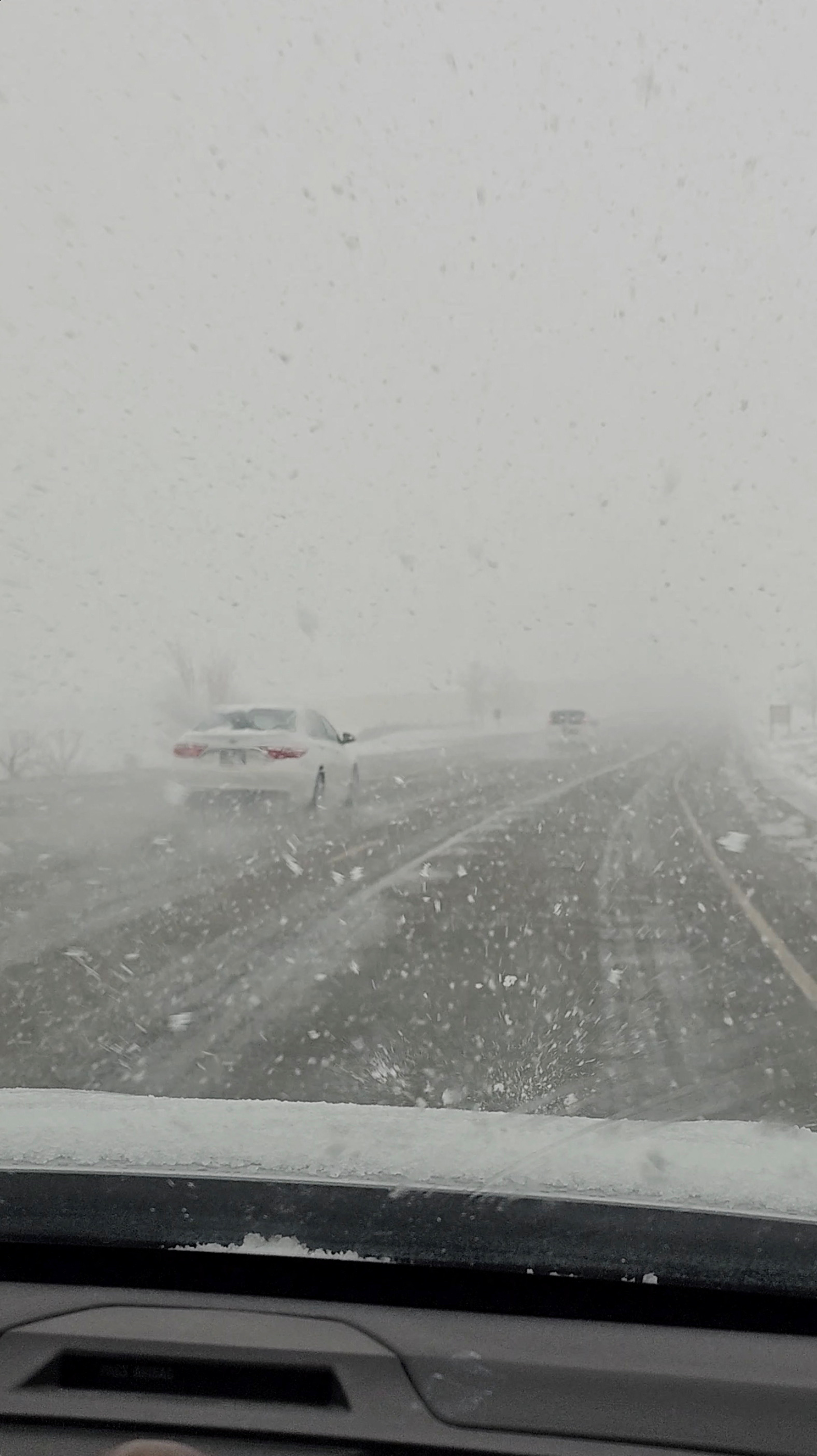 Vehicles drive during a snowstorm in Clearfield, Utah, U.S., March 20, 2023 in this screen grab taken from a social media video.