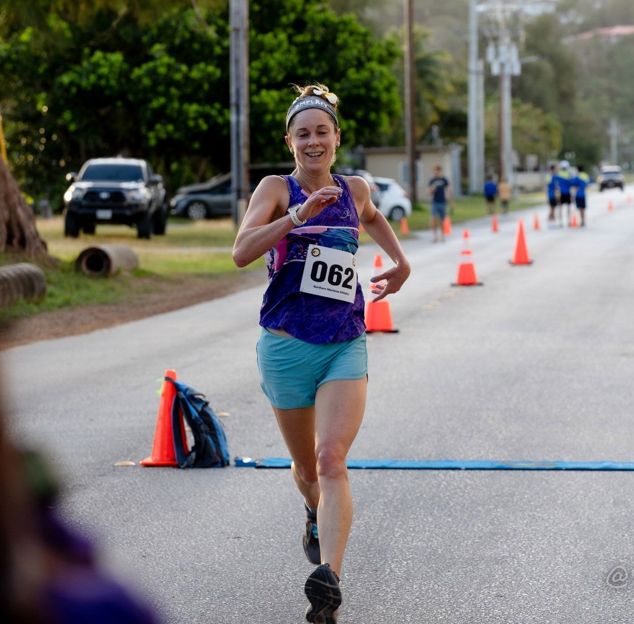 Lily Muldoon smiles as she crosses the finish line to top this year’s NMA NMI 10KM Women’s Run at American Memorial Park on Saturday.