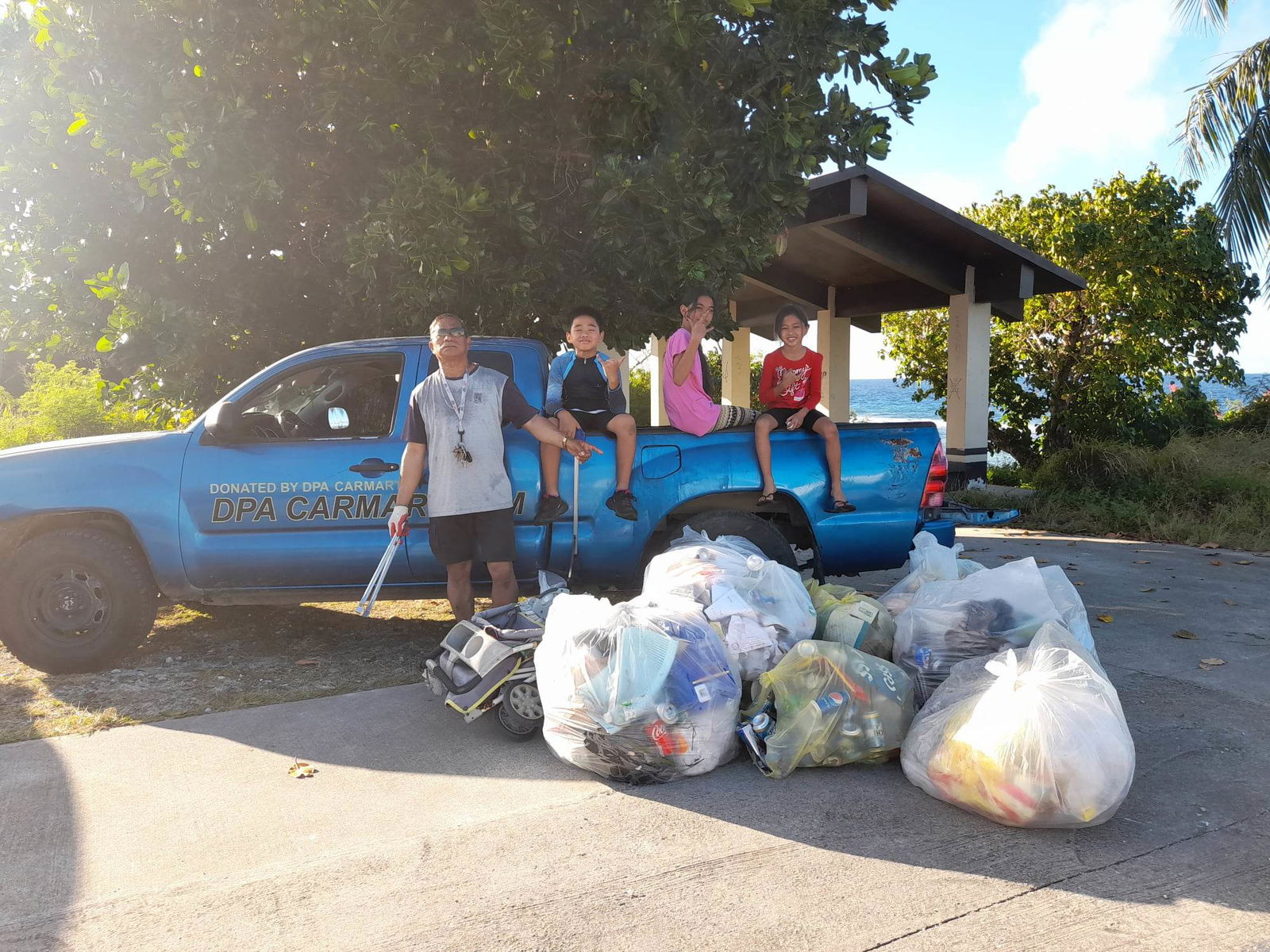 Max Aguon with his three grandchildren, Kiana, Damien, and Haylie.
