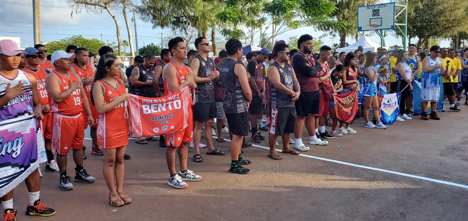 Team members and their muses gather at the Civic Center basketball court during the opening ceremony of the Saipan Centennial Basketball League, season two, on Sunday, March 19, 2023.