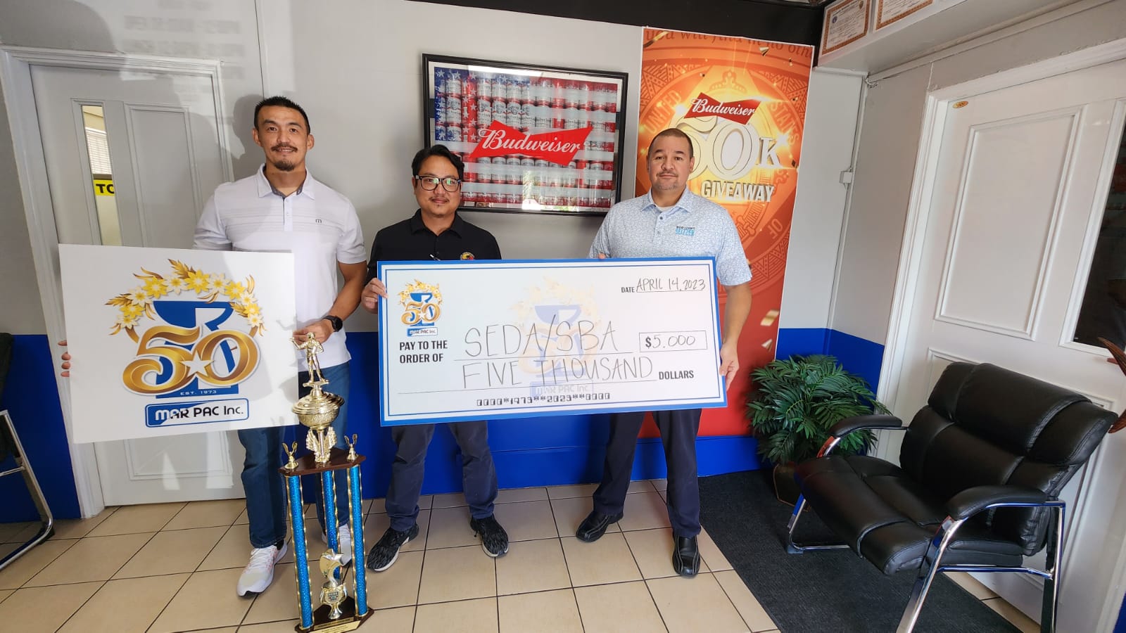 Marianas Pacific Distributors Inc. beverage and tobacco manager James Lee, left, and resident manager Guy R. Pudney, right, with Saipan Electronic Darts Association League secretary Ivan Sales who received Marpac’s donation for the 2023 Bud Light Dart League.
