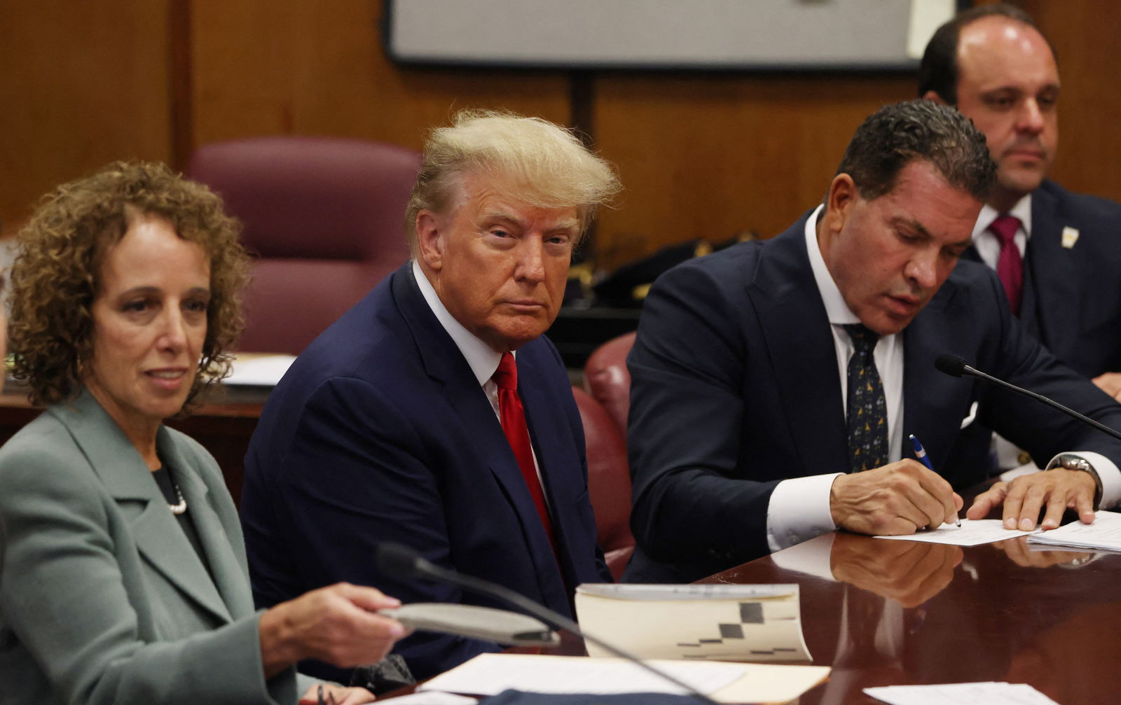 Former President Donald Trump is accompanied by members of his legal team, Susan Necheles and Joe Tacopina, as he appears in court for an arraignment on charges stemming from his indictment by a Manhattan grand jury, April 4, 2023.