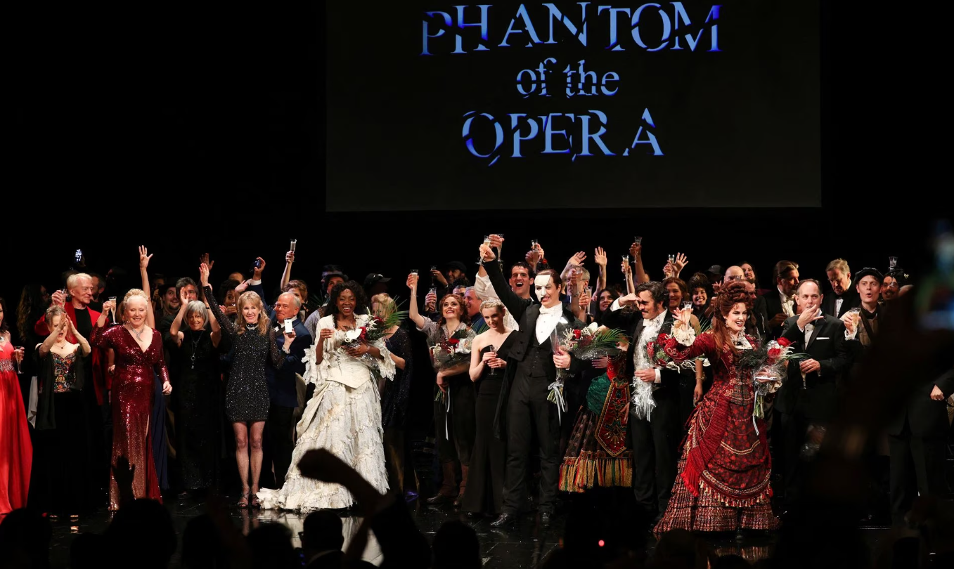 Cast and crew members take a moment to applause after their final performance of the “Phantom of the Opera.”