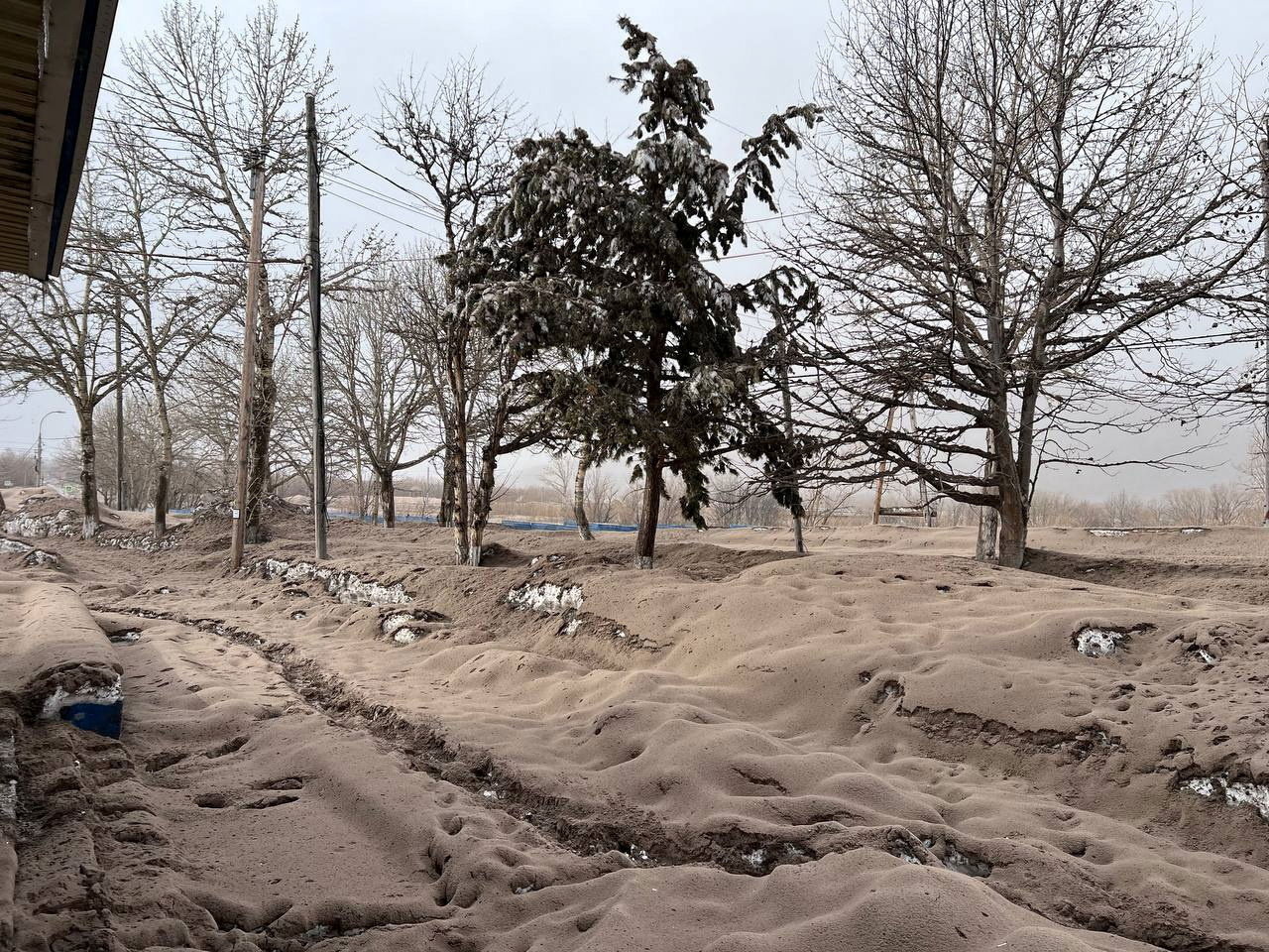 A view shows a street covered in volcanic dust following the eruption of Shiveluch volcano in the settlement of Klyuchi on the Kamchatka Peninsula, Russia April 11, 2023. Official page of Oleg Bondarenko, Head of the Ust-Kamchatsky municipal district/Handout via REUTERS