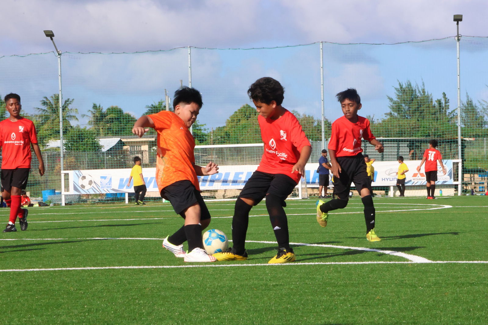 A Kanoa Football Club player and a Matansa Football Club player battle for the possession during a U14 boys division game of the TakeCare Youth Soccer League at the NMI Soccer Training Center.