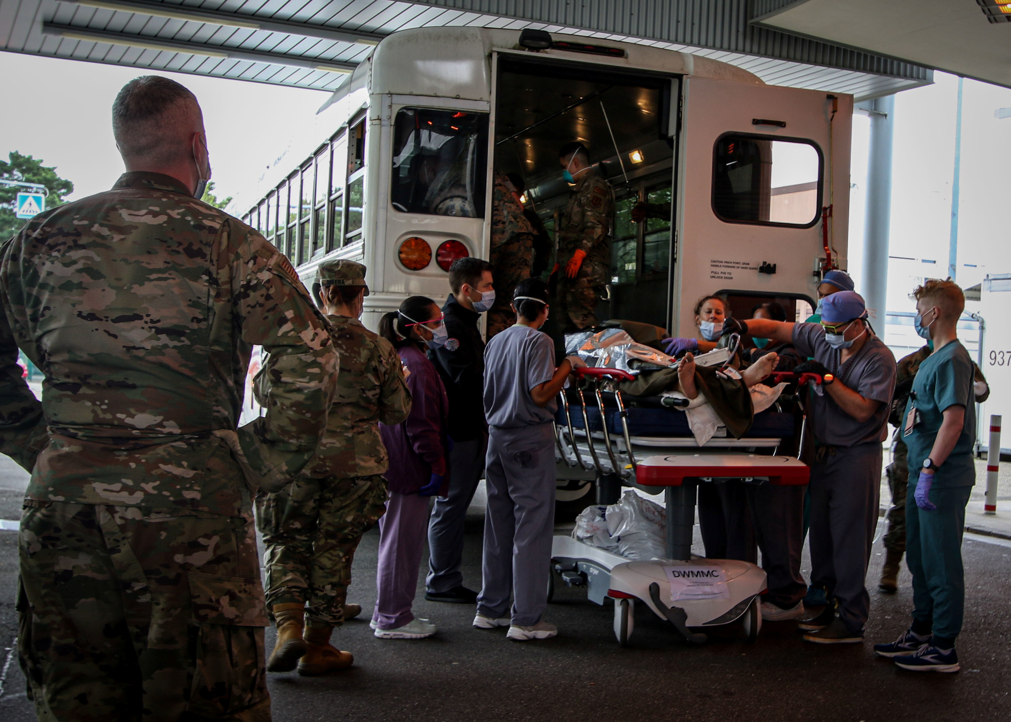 FILE PHOTO: U.S. Soldiers, Airmen and civilian staff receive casualties who were injured outside of Hamid Karzai International Airport and evacuated to the U.S. Army-operated Landstuhl Regional Medical Center (LRMC) for further care in Landstuhl, Germany August 27, 2021. Landstuhl Regional Medical Center/Marcy Sanchez/Handout via REUTERS