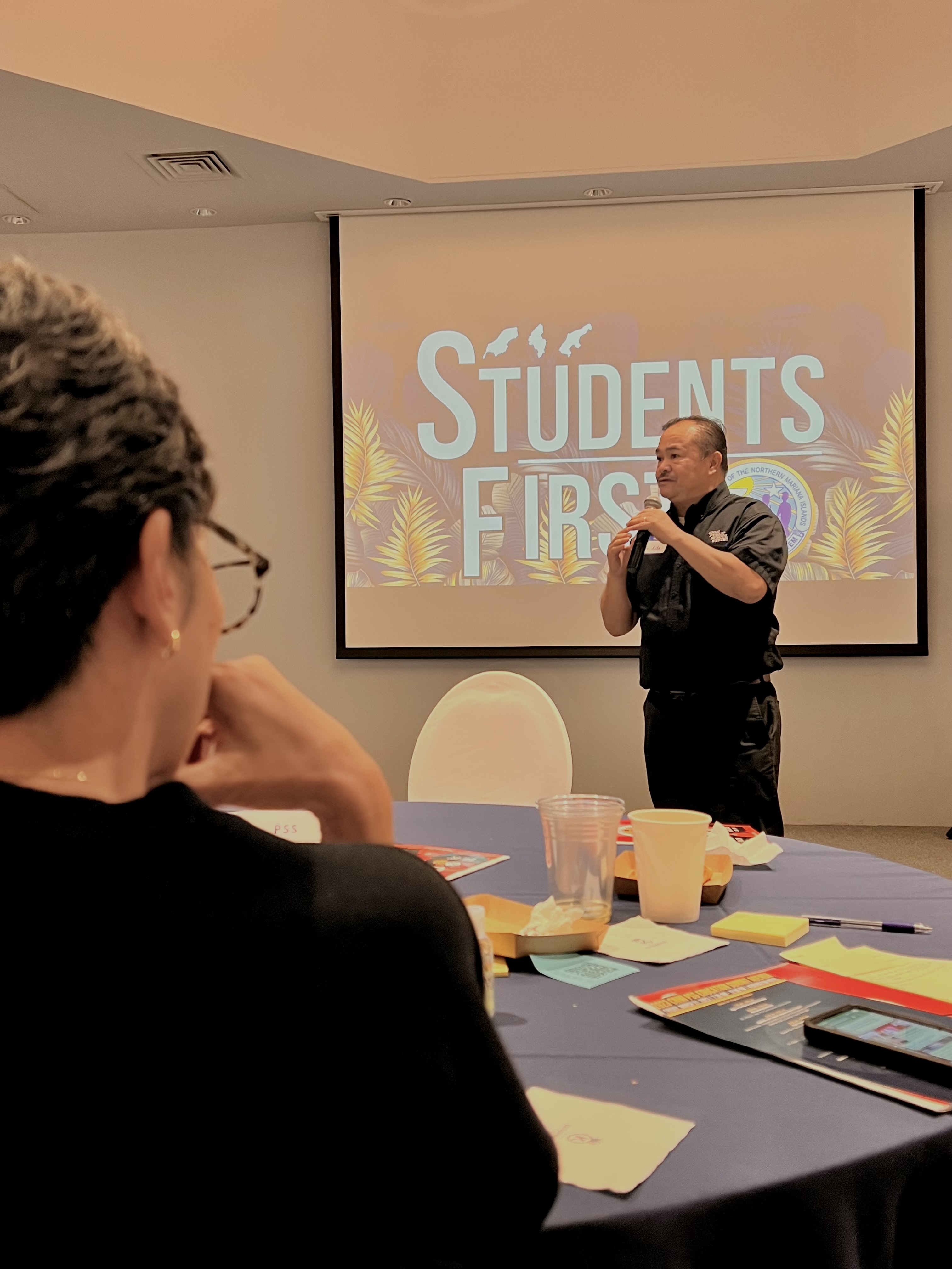 Commissioner of Education Dr. Alfred B. Ada, right, fields questions as Rep. Marissa Flores, foreground, listens.