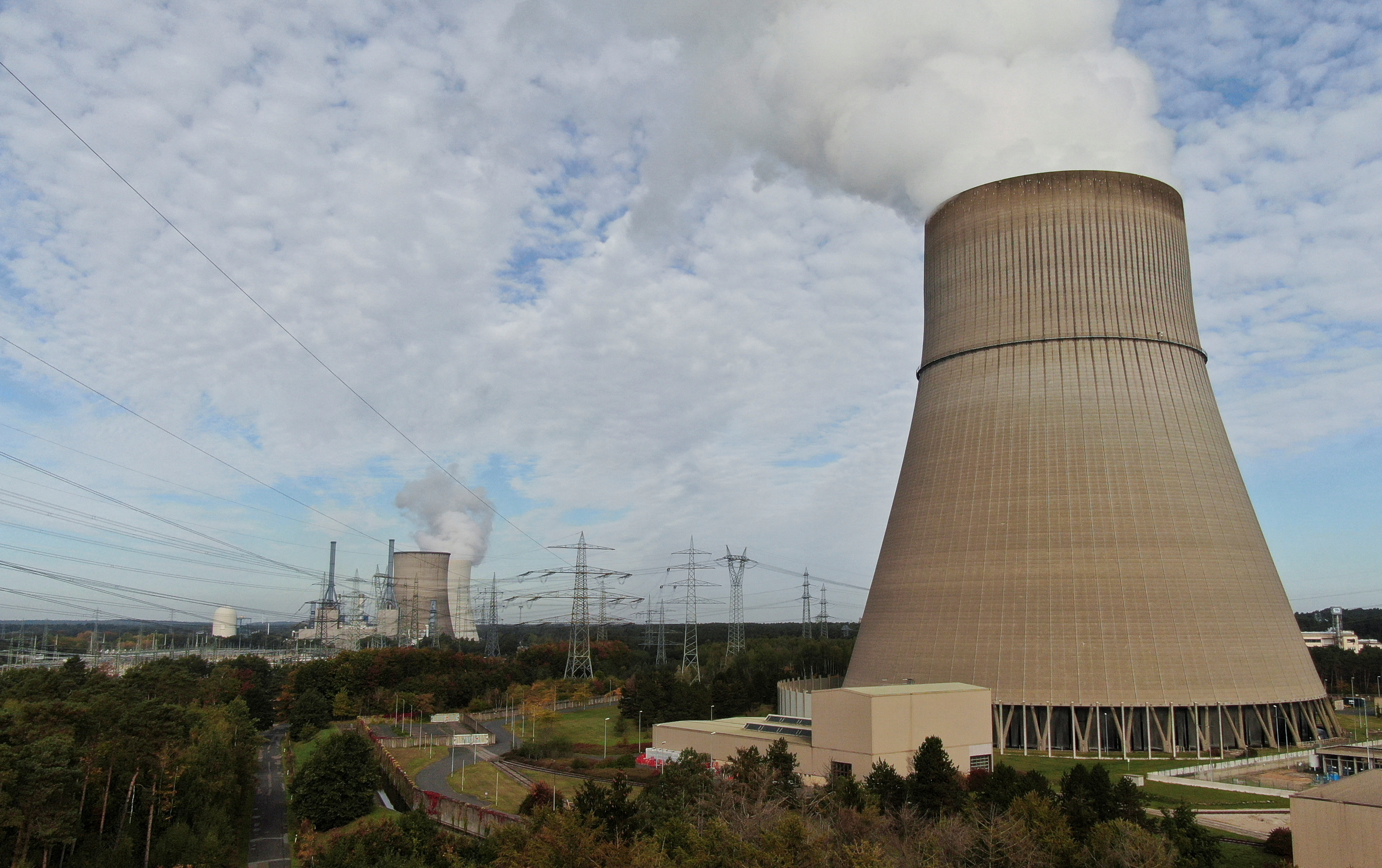 FILE PHOTO: An aerial view shows the cooling tower of Emsland nuclear power plant and in rear the cooling towers of Emsland natural gas power plants of German utility RWE, amid the energy crisis caused by Russia's invasion of Ukraine, on the outskirts of Lingen, Germany, October, 12, 2022. REUTERS/Stephane Nitschke