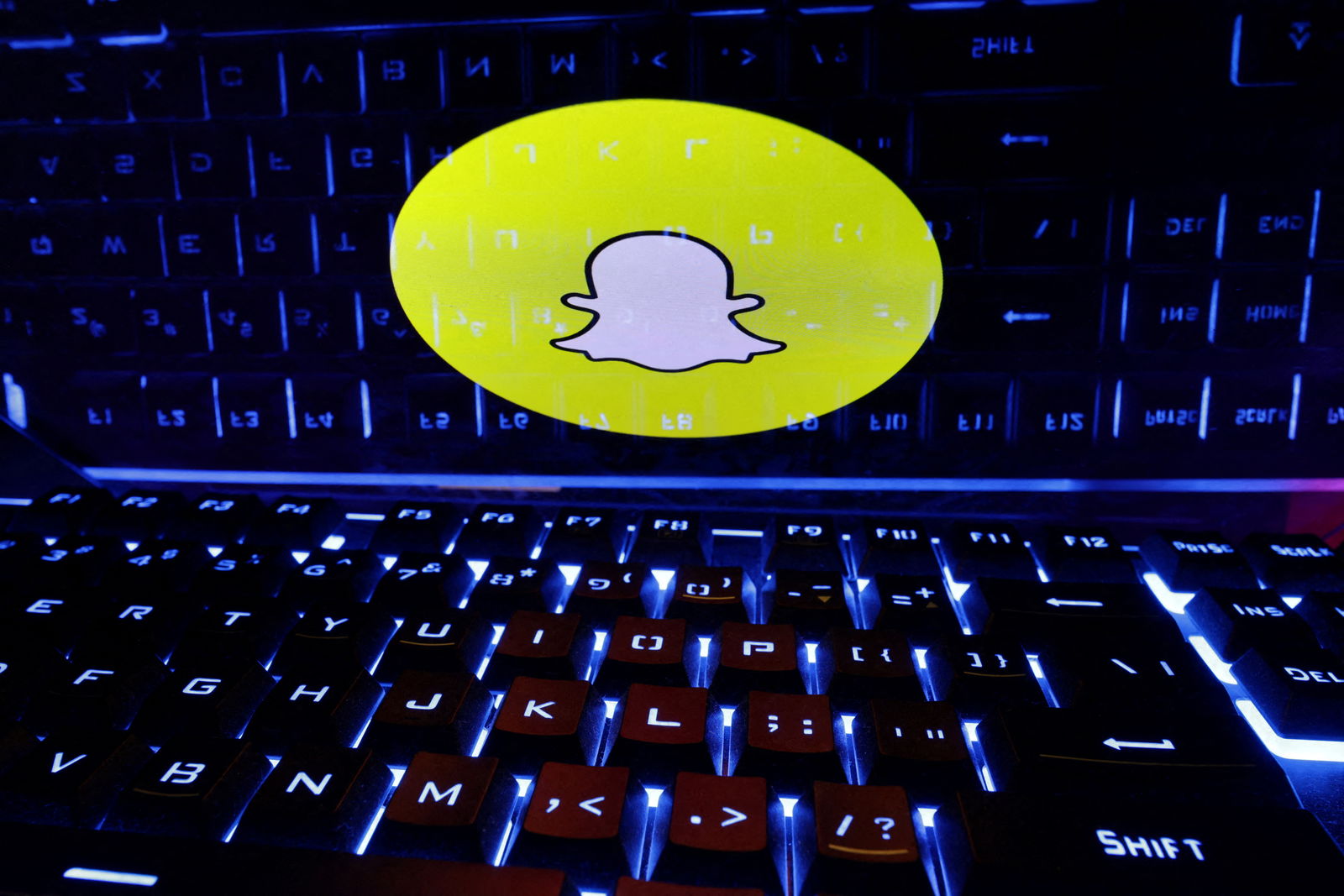 FILE PHOTO: A keyboard is placed in front of a displayed Snapchat logo in this illustration taken February 21, 2023. REUTERS/Dado Ruvic/Illustration/File Photo