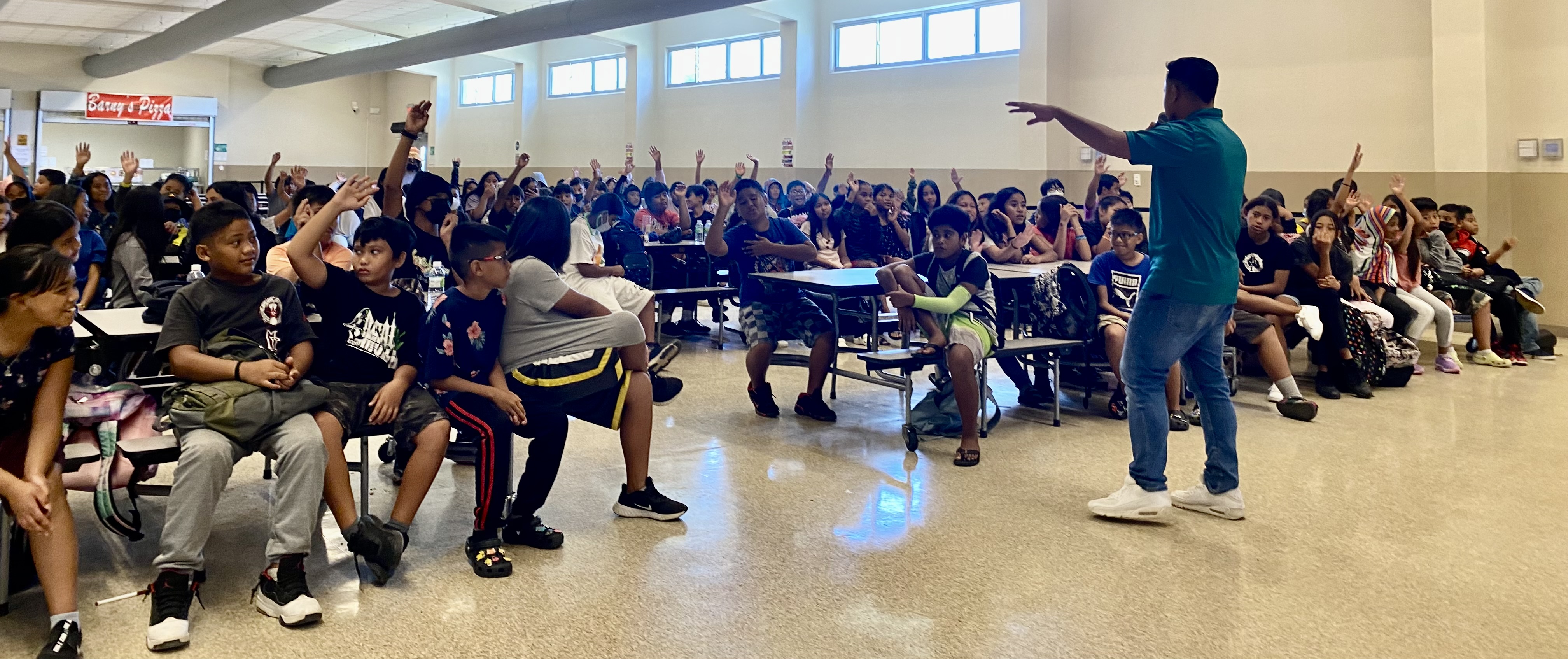 Students of Koblerville Elementary who have participated in a signature event of the Marianas Visitors Authority respond to MVA Community Projects Specialist Jack Aranda at the educational outreach presentation of MVA and the Marianas Tourism Education Council at the school on March 28, 2023.