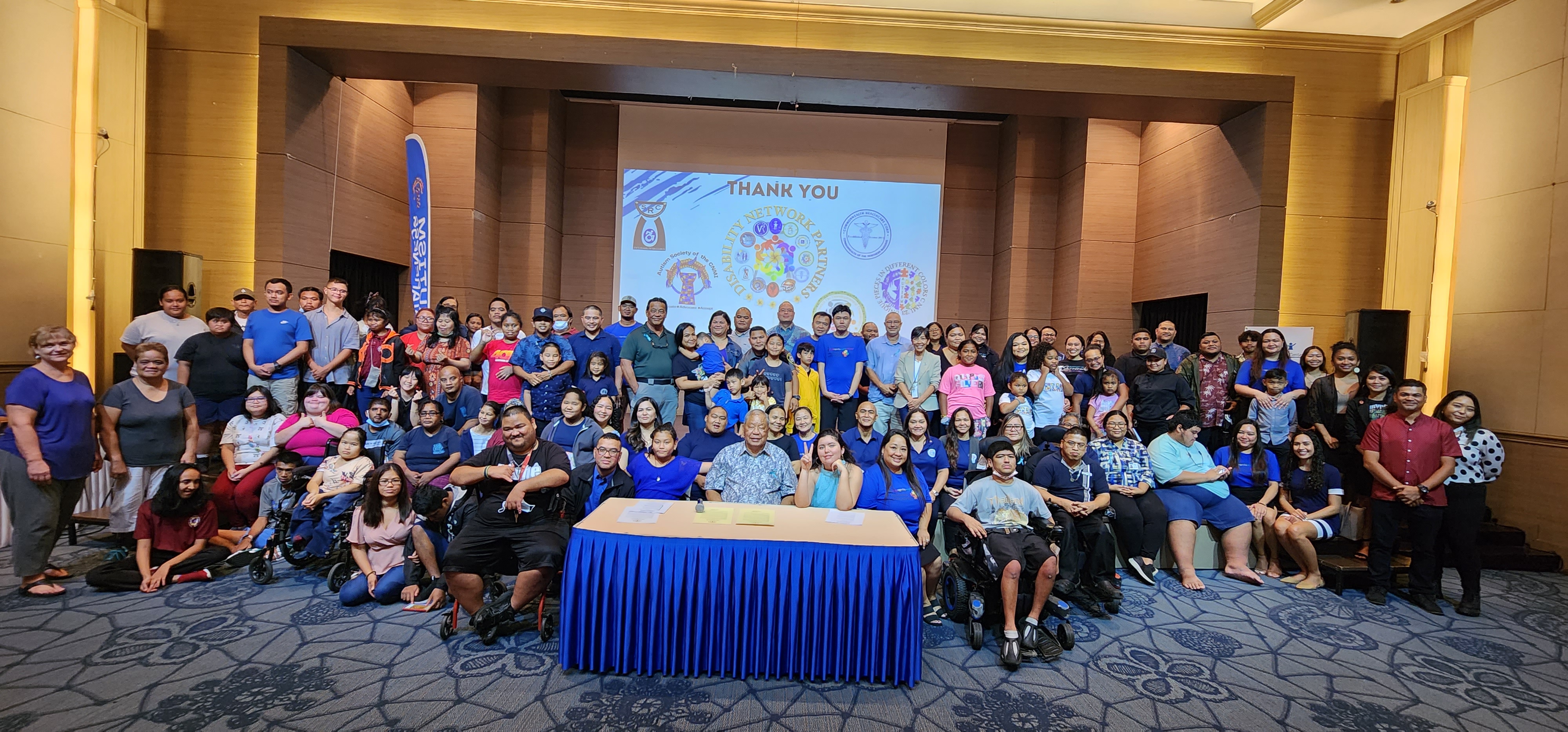 Acting Gov. David M. Apatang poses for a photo with other CNMI officials, advocates and community members after signing a proclamation designating April as Autism Awareness Month on Monday at Saipan World Resort.