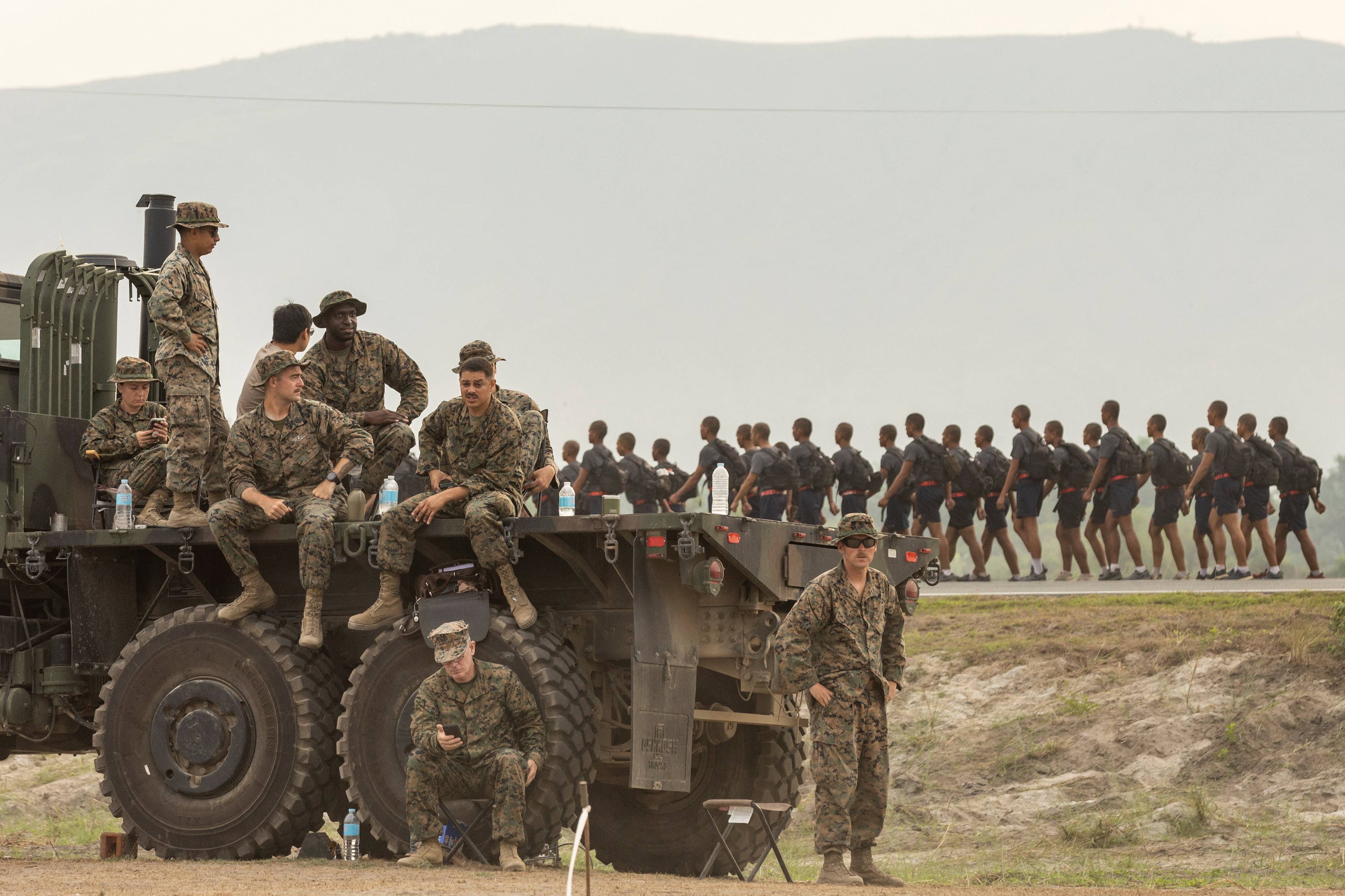 U.S. troops look on as Philippine military cadets train at a naval base where the annual joint military exercises between U.S. and Philippine troops called "Balikatan" or shoulder-to-shoulder are held in San Antonio, Zambales province, Philippines, April 26, 2023. REUTERS/Eloisa Lopez