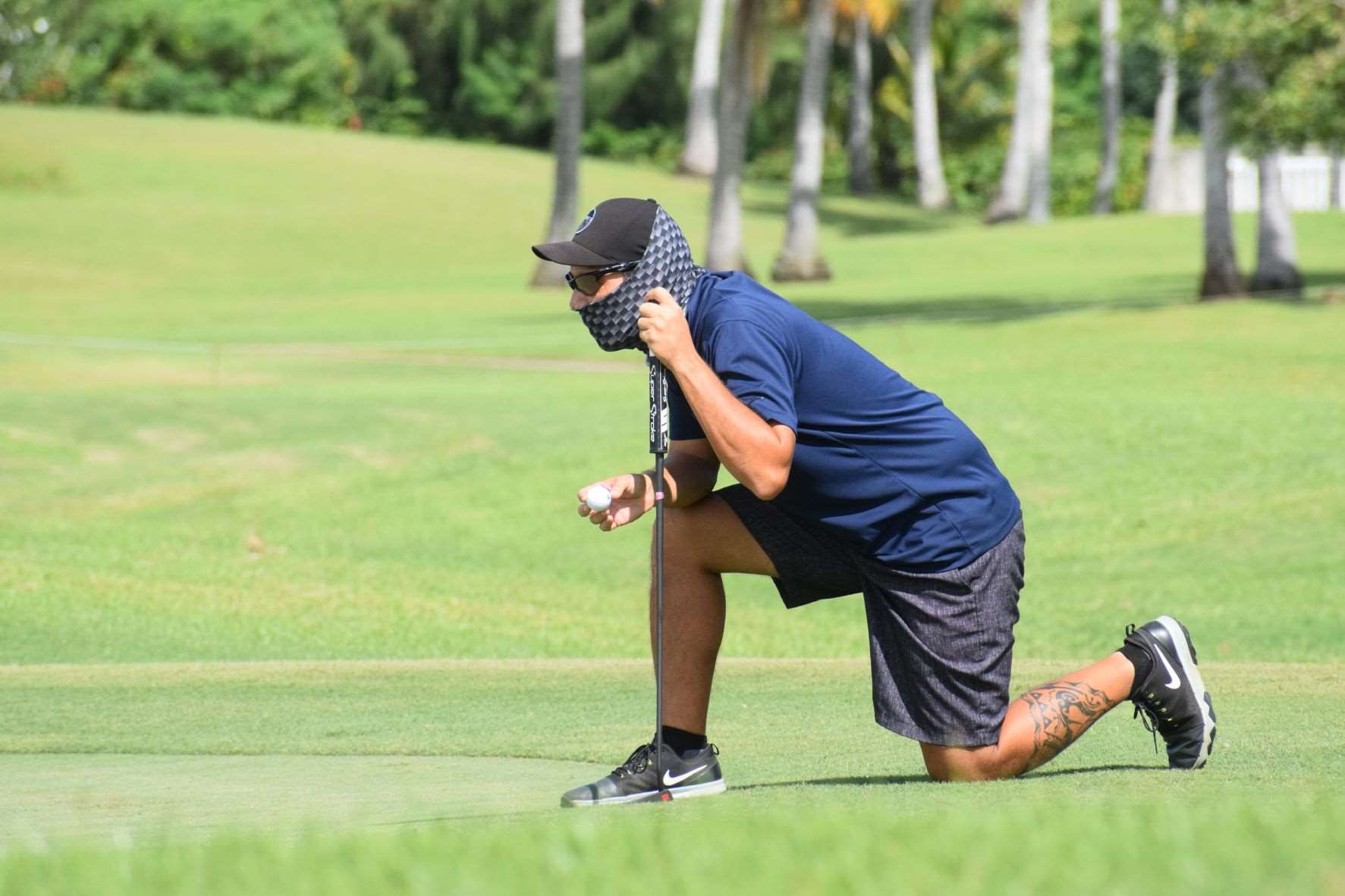 Amigos Golf Club's Dung Tenorio gauges the green during a tournament at LaoLao Bay Golf & Resort.