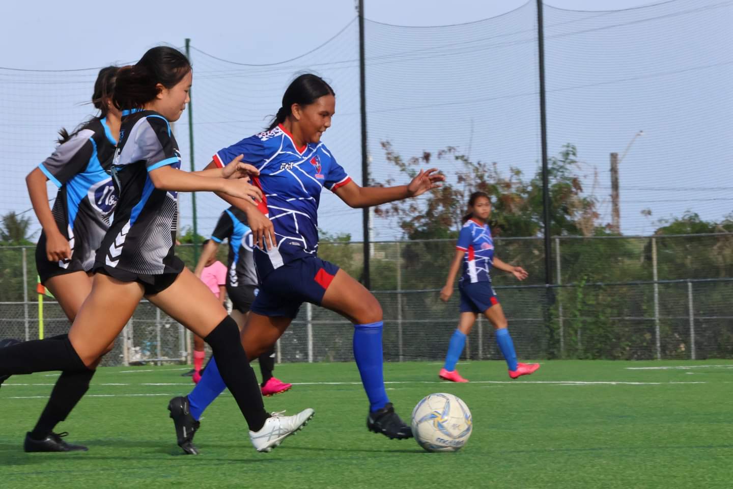 Shirley's Football Club's Alyssa Borlongan dribbles past two defenders during a U17 girls division game of the TakeCare Youth Soccer League at the NMI Soccer Training Center in Koblerville.