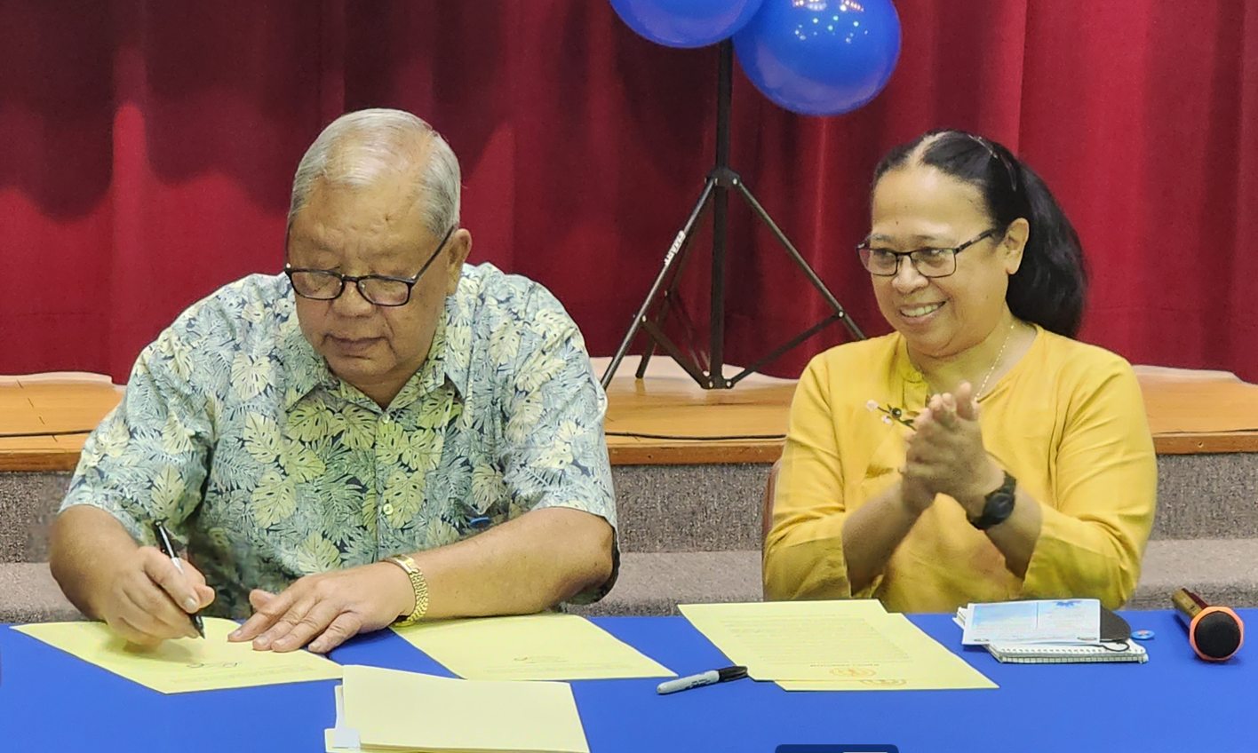 Department of Community and Cultural Affairs Secretary Mary Margaret Sablan applauds while acting Gov. David M. Apatang signs the Child Abuse and Neglect Prevention and Awareness Month proclamation on Tuesday at the multi-purpose center.