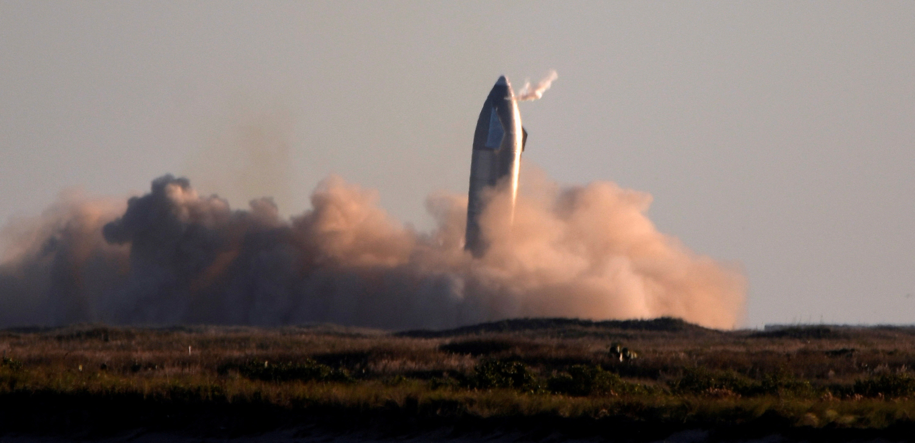 FILE PHOTO: SpaceX's first super heavy-lift Starship SN8 rocket during a return-landing attempt after it launched from their facility on a test flight in Boca Chica, Texas U.S. December 9, 2020. REUTERS/Gene Blevins/File Photo