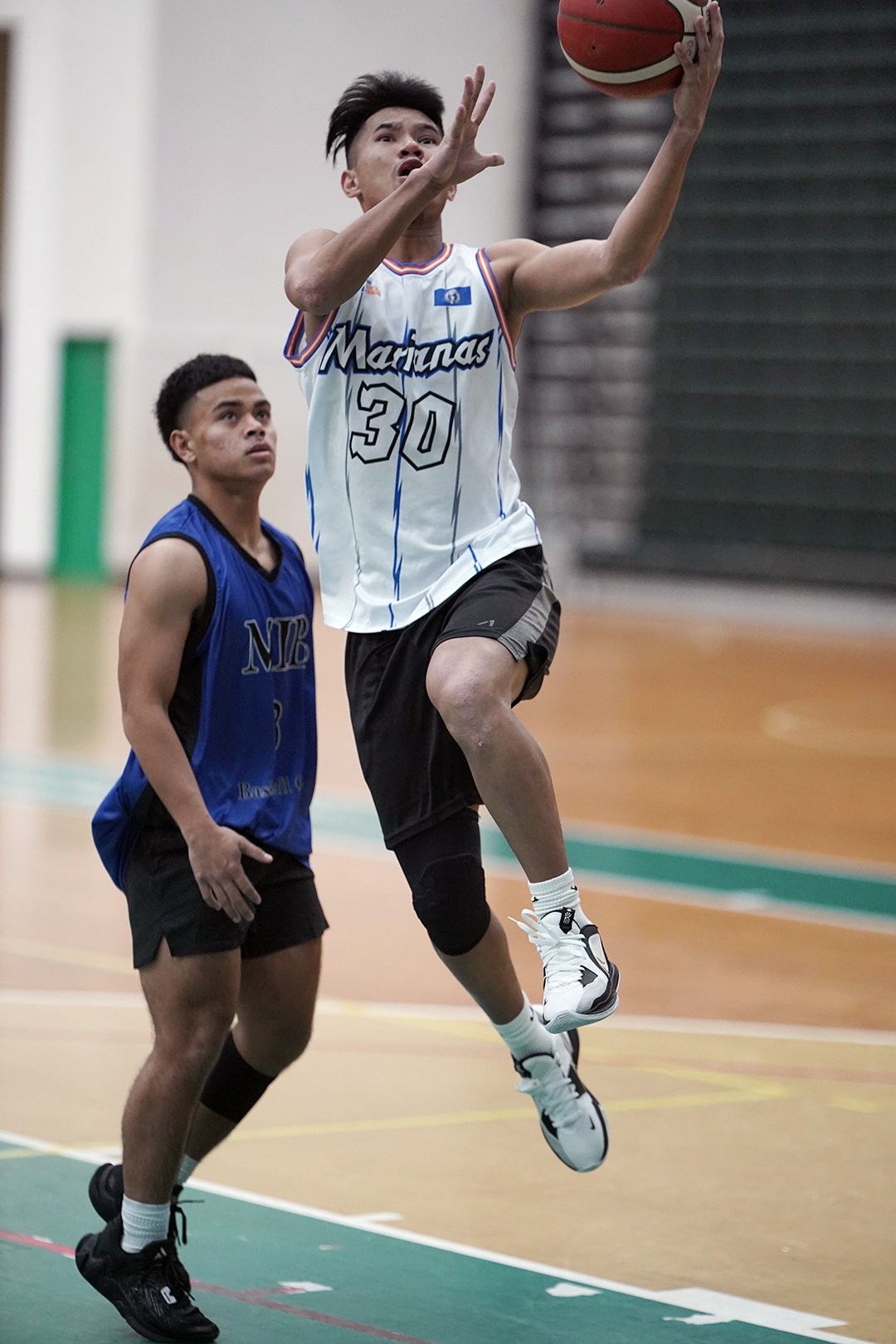 Team Marianas' Ervin Villarin takes off for the finish at the rim during a game of the 2nd Annual UOG Friendship Games at the UOG Calvo Field House.