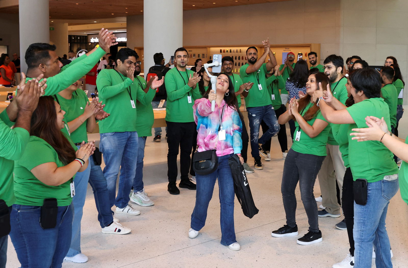 Apple employees welcome bloggers and journalists inside India's first Apple retail store during a media preview, a day ahead of its launch in Mumbai, India, April 17, 2023. REUTERS/Francis Mascarenhas